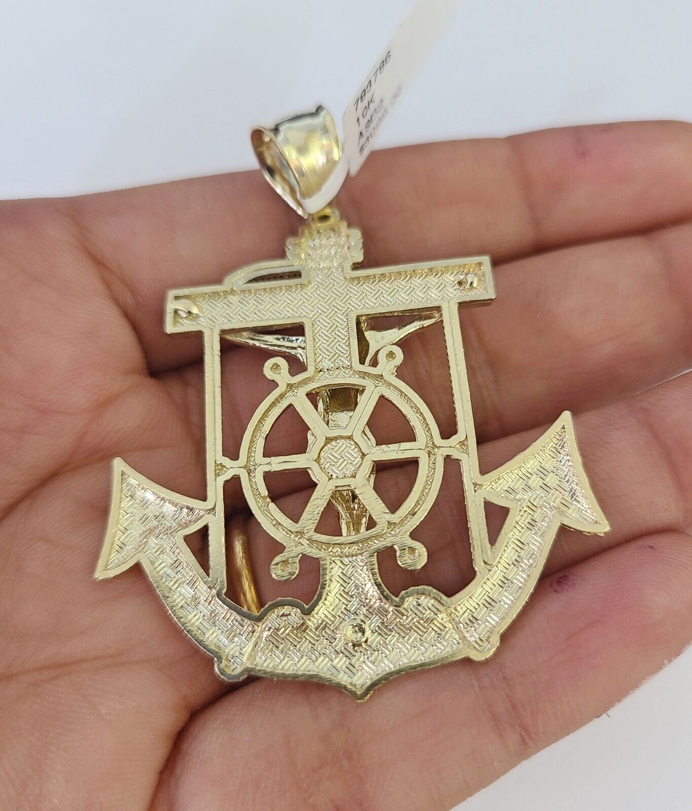Close-up of 10K yellow gold Jesus anchor pendant on Franco chain necklace