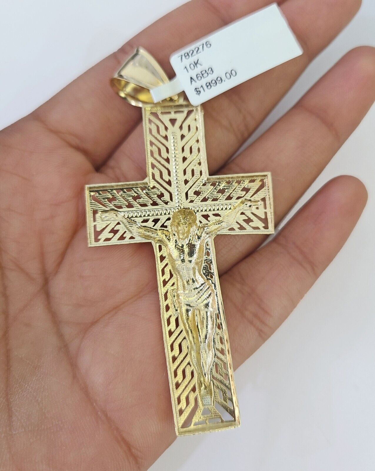 10K yellow gold Jesus cross pendant on a Franco chain necklace by Reva Jeweler