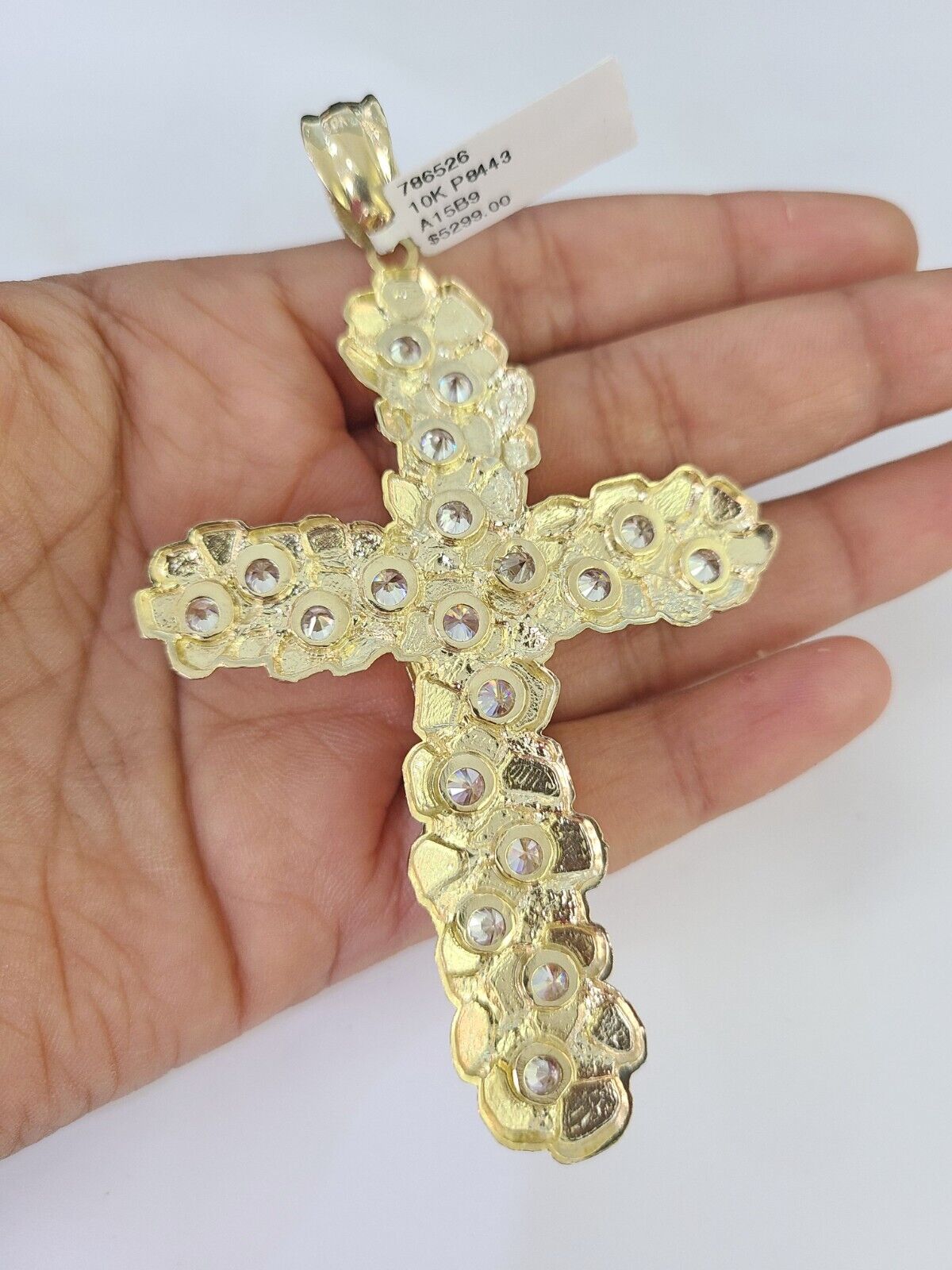Lifestyle or alternate angle view of 10K gold crucifix necklace by Reva Jeweler