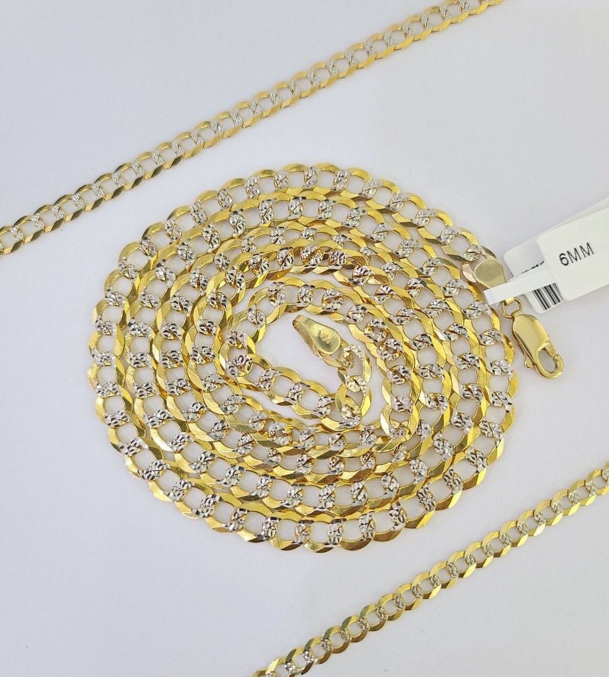 Detailed view of the lobster clasp on the 10k gold diamond-cut Cuban curb chain
