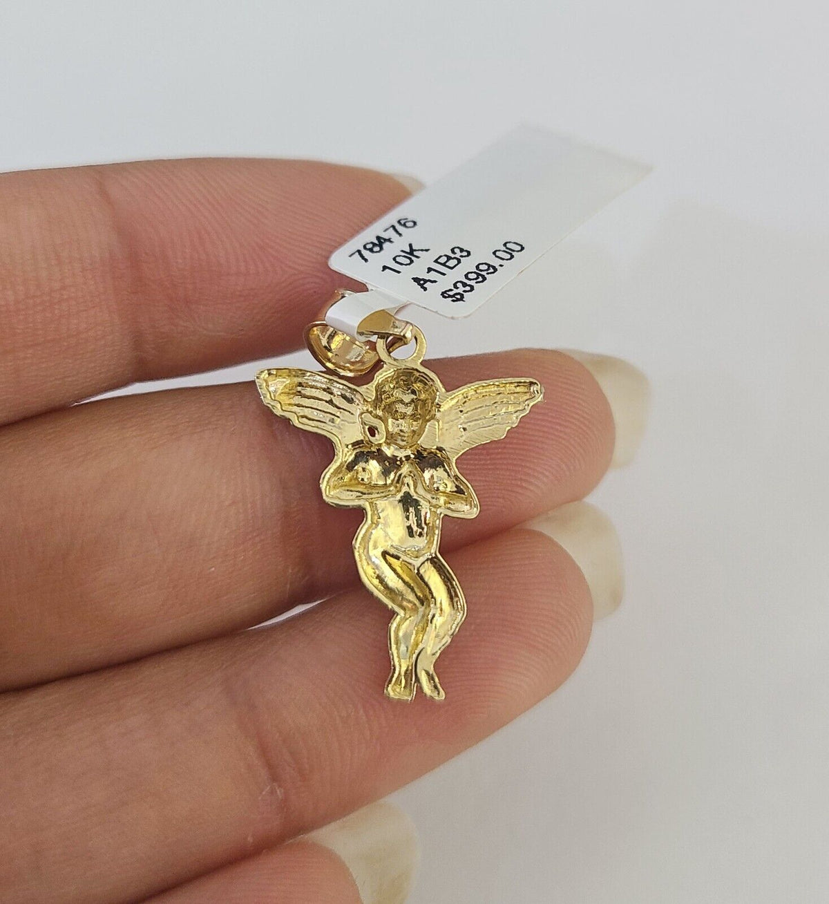 Flat lay of praying angel necklace