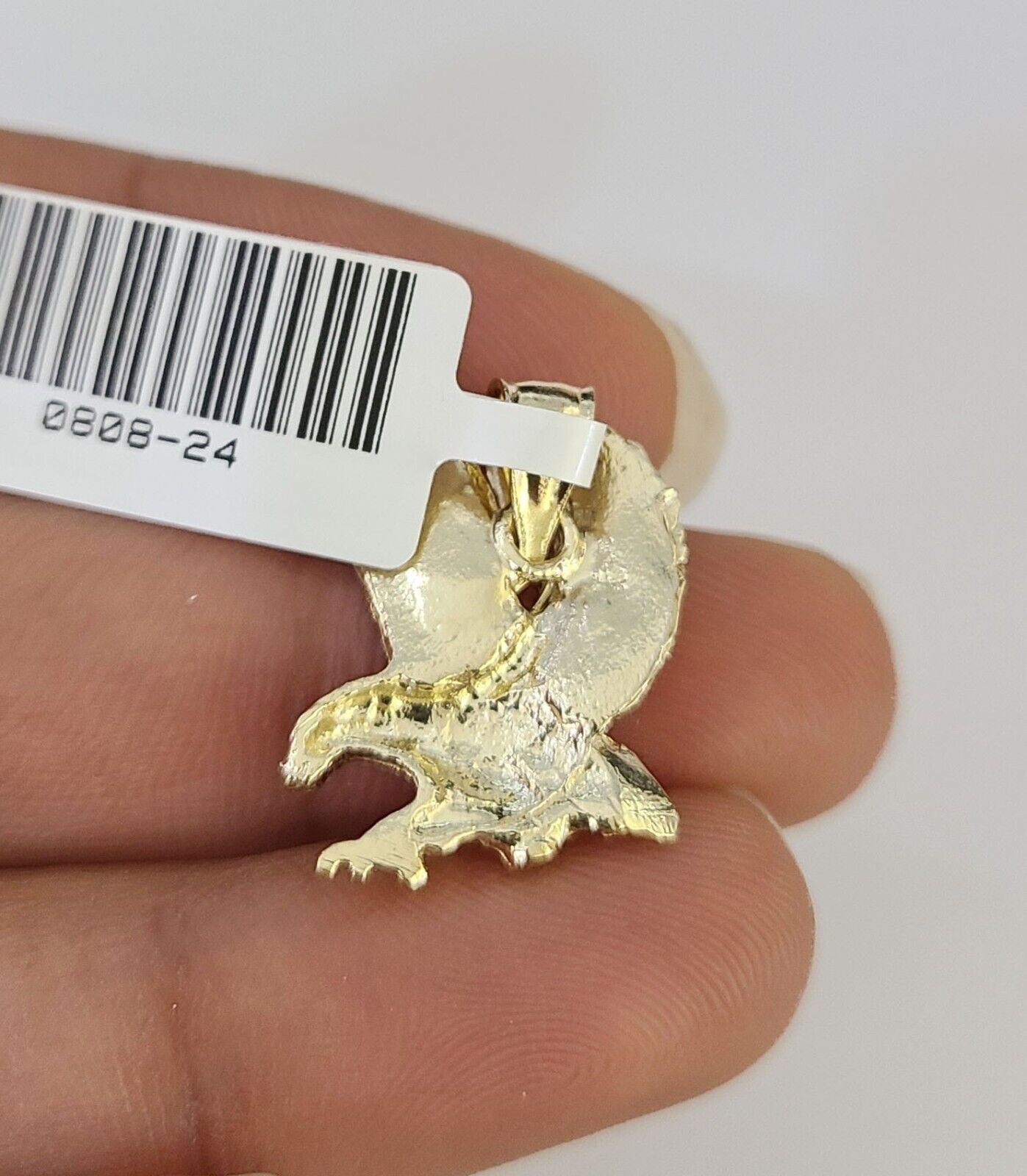 Gold eagle pendant flat lay