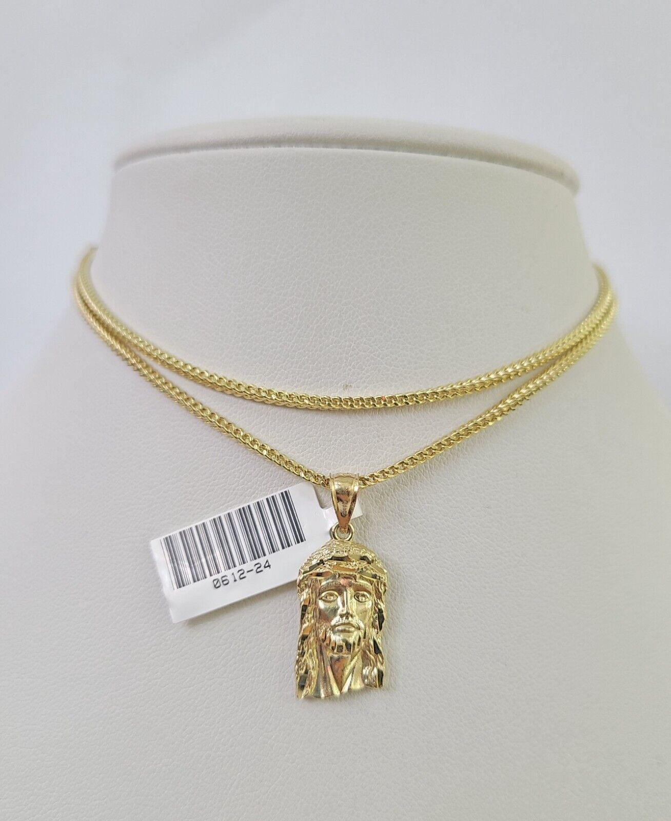 Front-facing view of Reva Jeweler 10K gold Jesus head pendant and chain