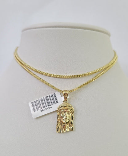 Front-facing view of Reva Jeweler 10K gold Jesus head pendant and chain
