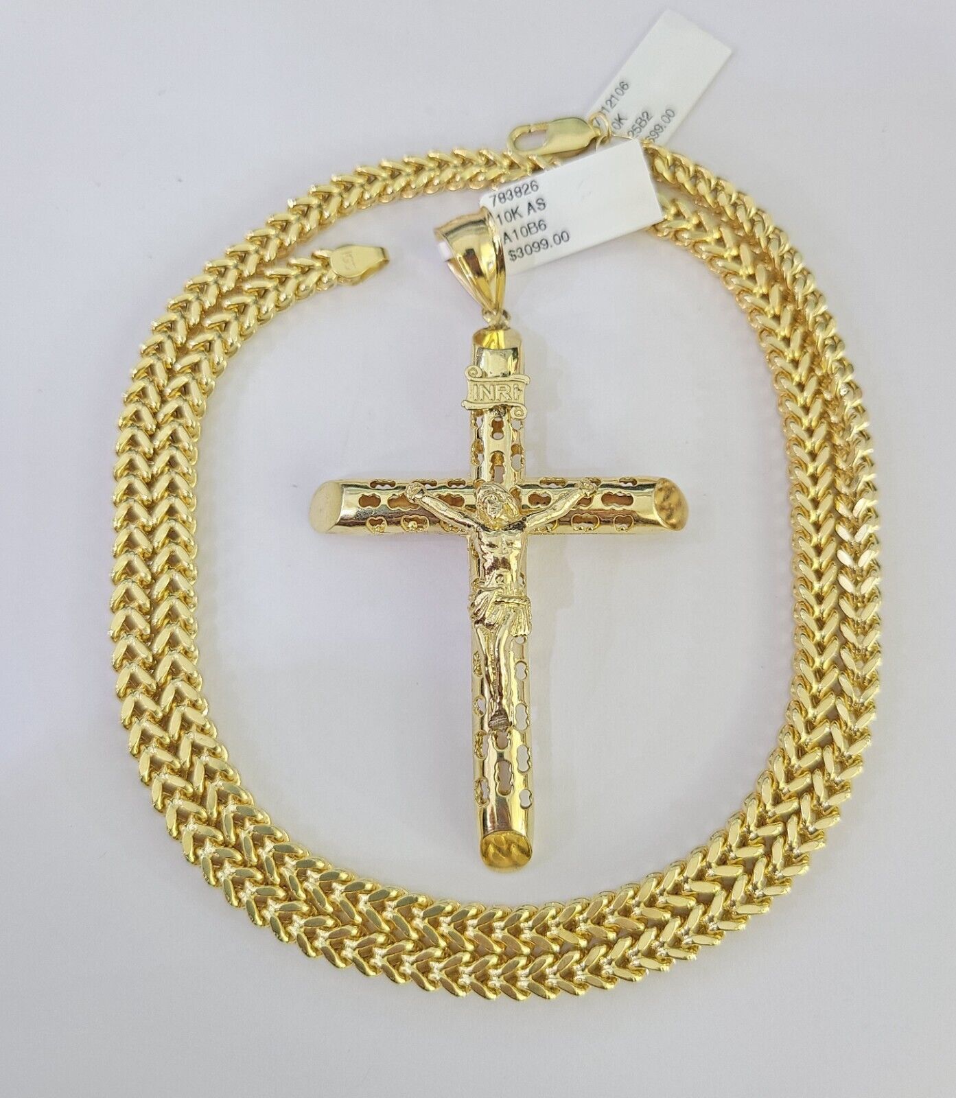 Close-up detail of INRI engraving on Jesus cross pendant in 10K gold