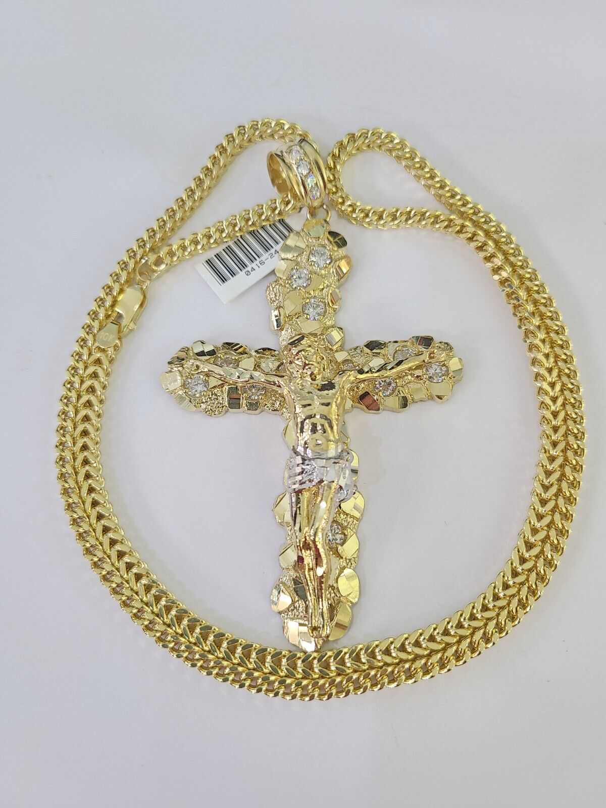 Close-up detailed view of 10K yellow gold Jesus crucifix pendant charm