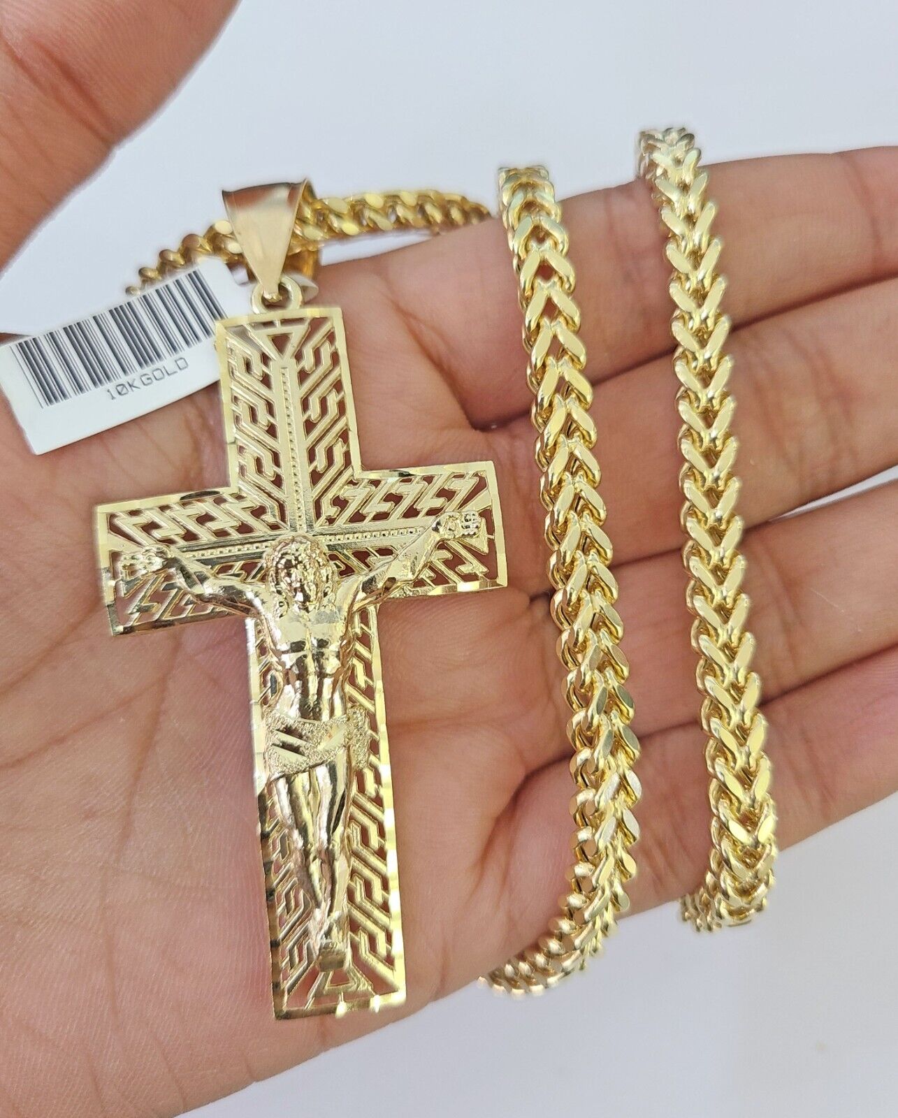 Close-up of 10K gold Jesus cross pendant charm from Reva Jeweler