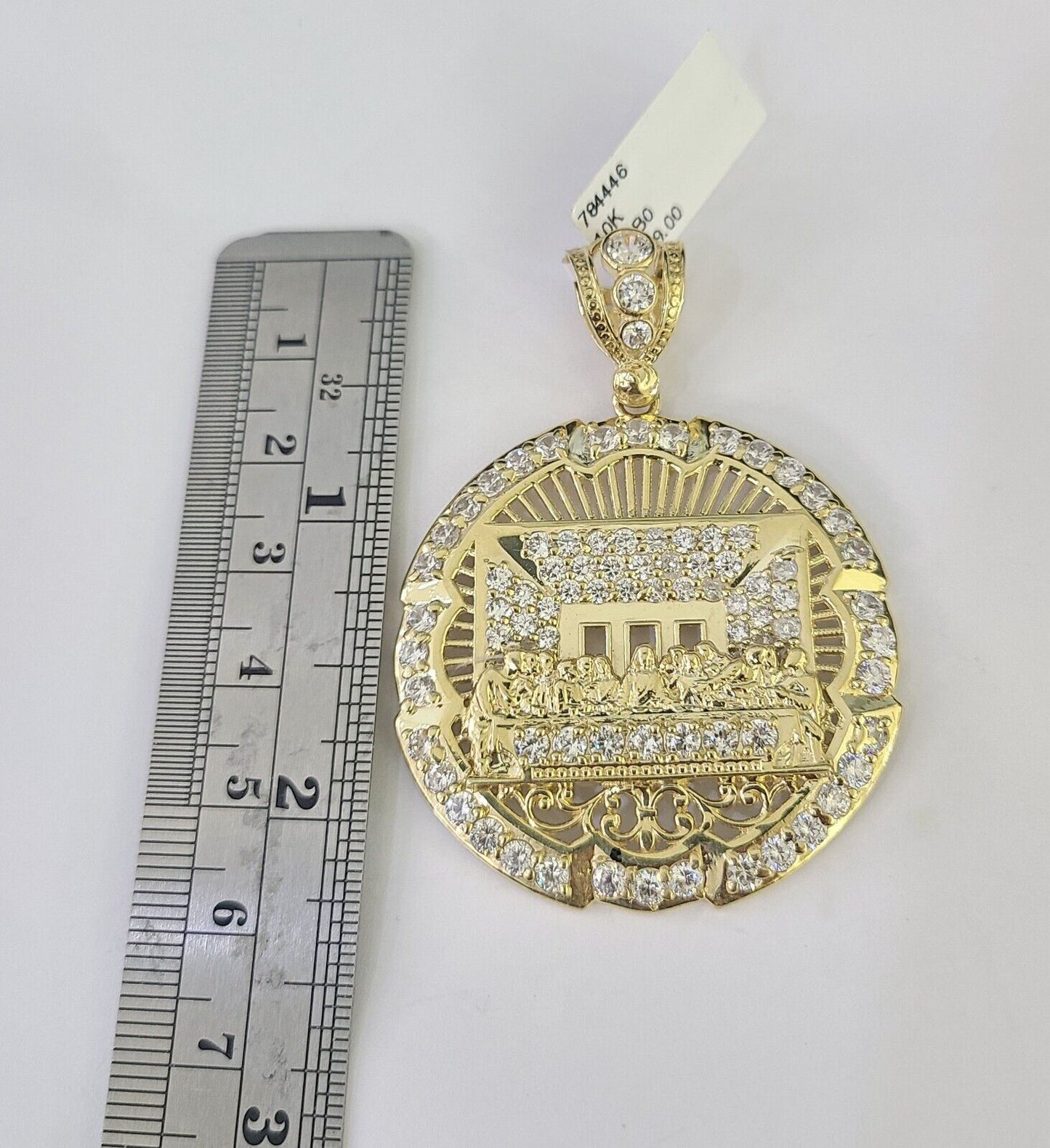 Flat lay display of Reva Jeweler 10K yellow gold Last Supper necklace set