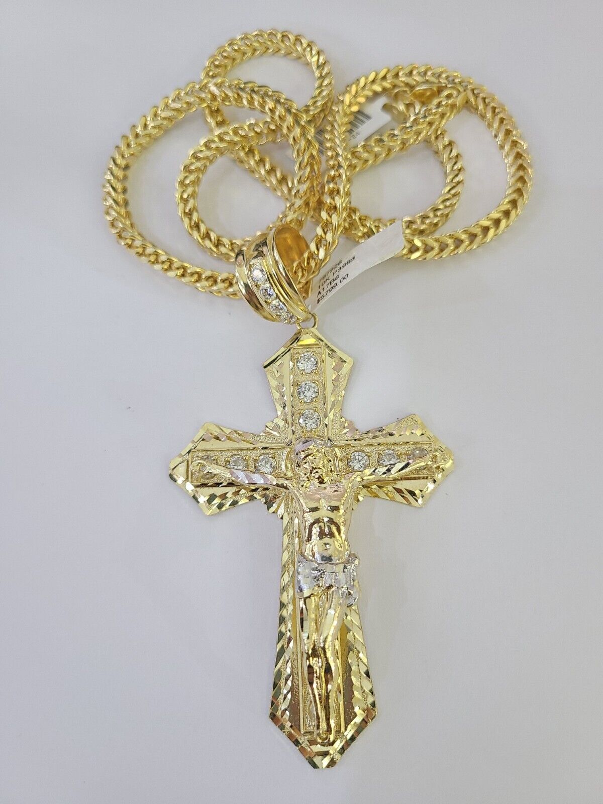 10K yellow gold Jesus cross pendant paired with a Franco chain necklace by Reva Jeweler