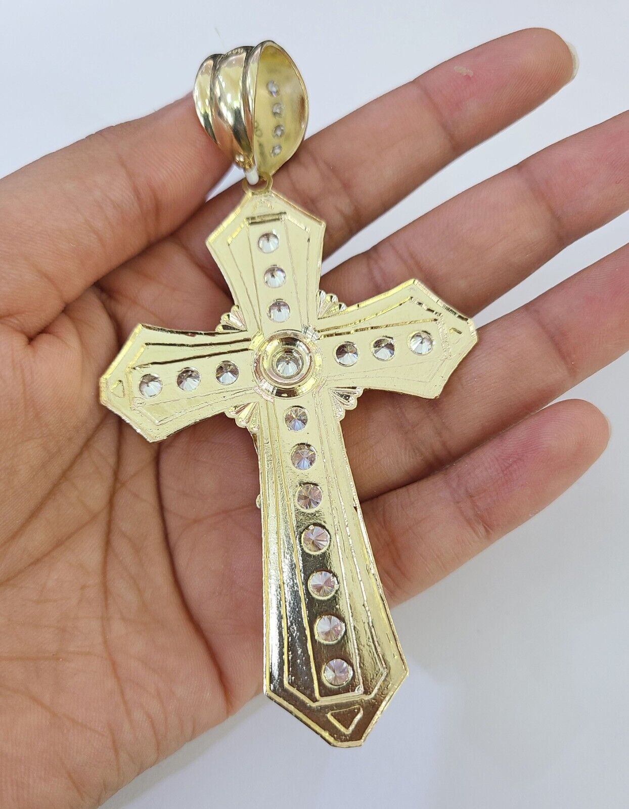 Side angle perspective of the 10K yellow gold Jesus cross pendant