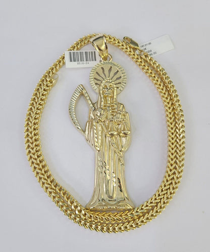 Side angle view of 10K yellow gold Saint Reaper pendant on Franco chain
