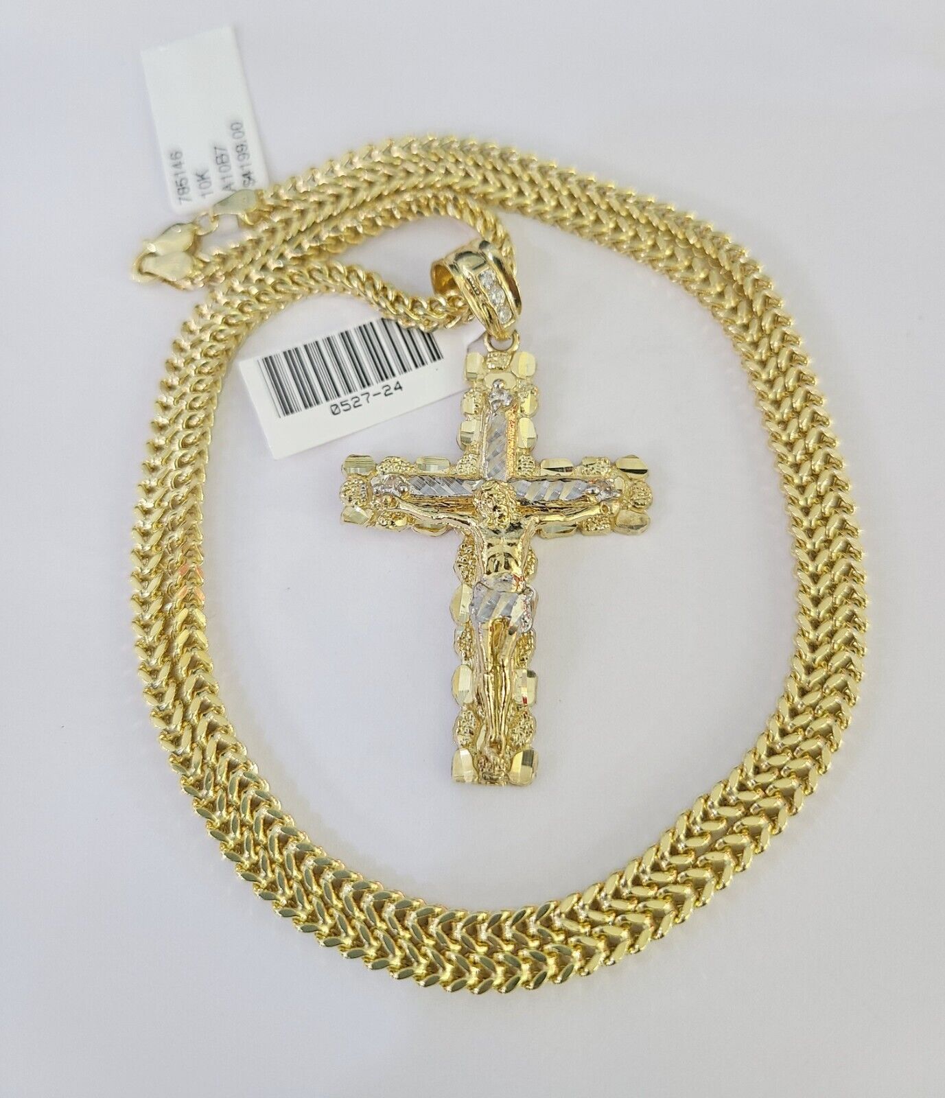 Close-up of 10K yellow gold Jesus cross pendant on Franco chain necklace
