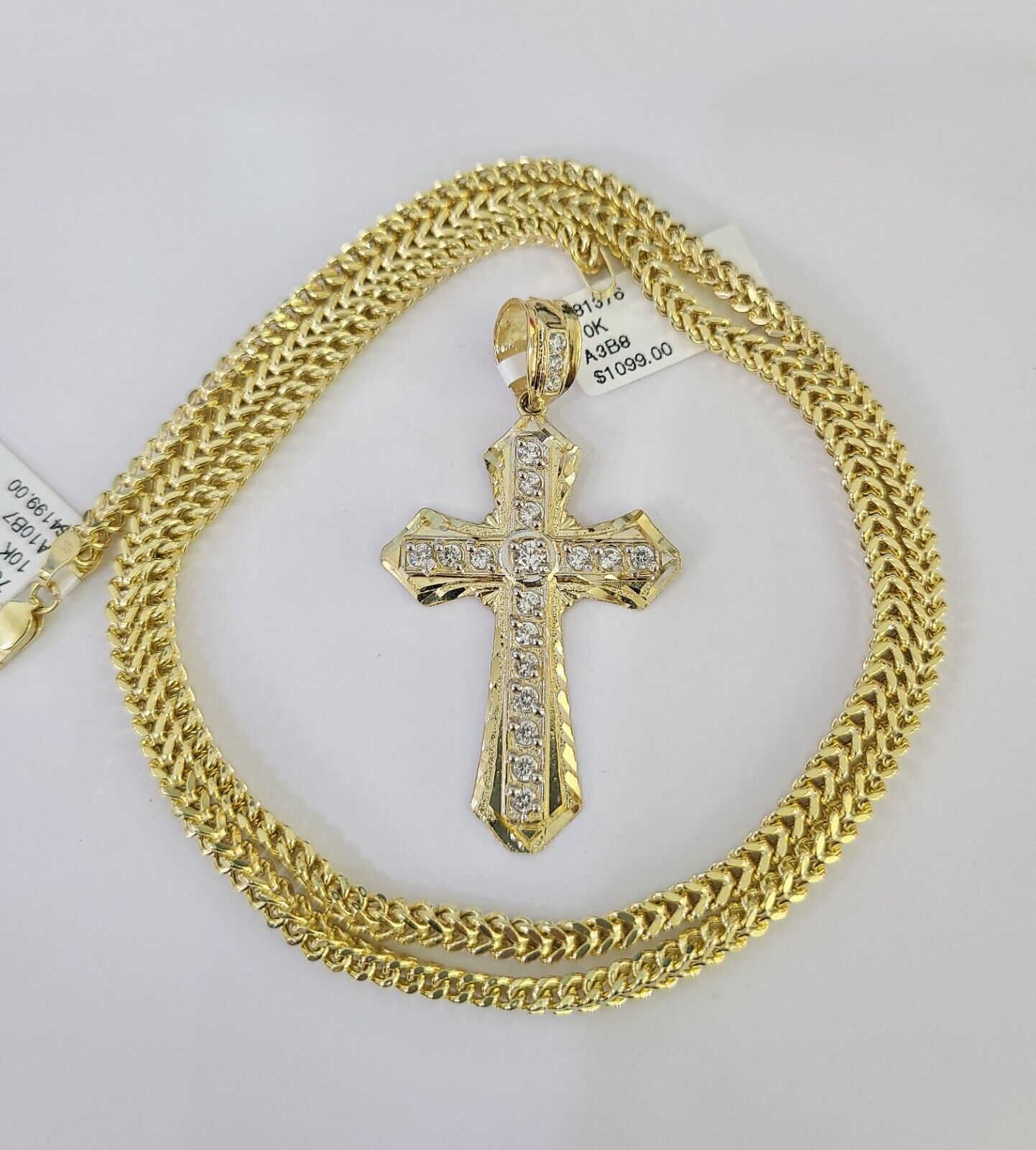 Close-up of 10K yellow gold Jesus cross pendant on Franco chain necklace