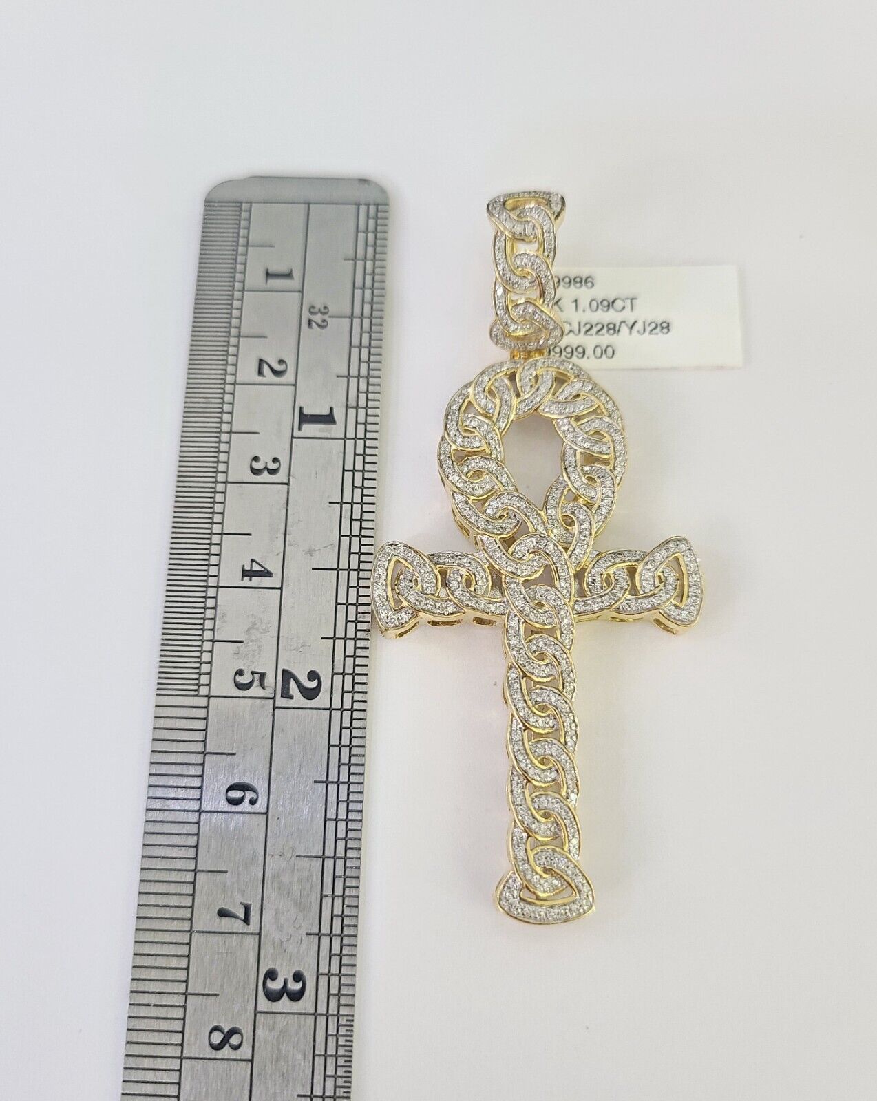 Close-up of 10K yellow gold diamond Jesus cross pendant on Franco chain