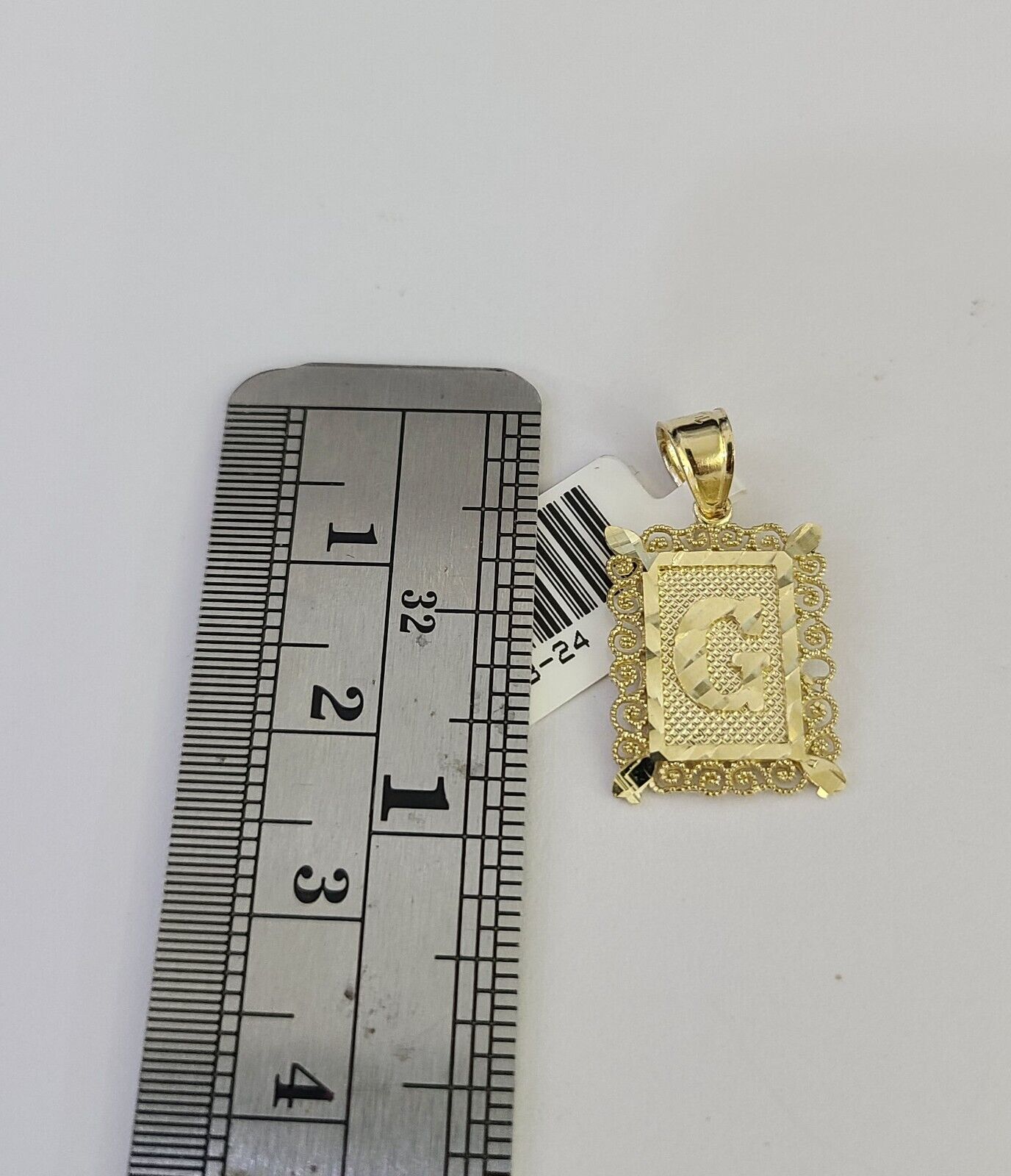 Gold letter pendant flat lay
