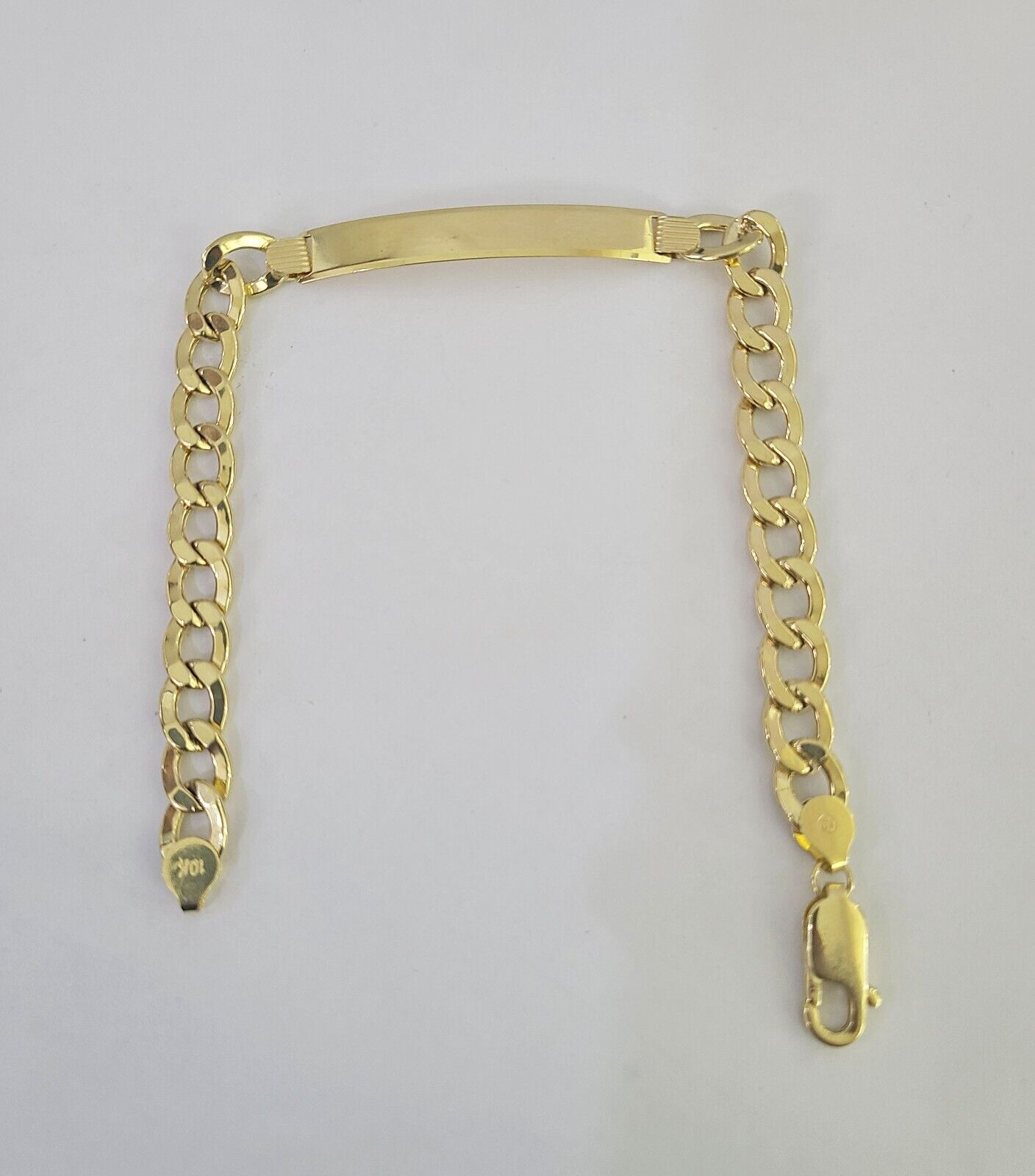 Close-up of 10K Yellow Gold Cuban Link ID Bracelet by Reva Jeweler