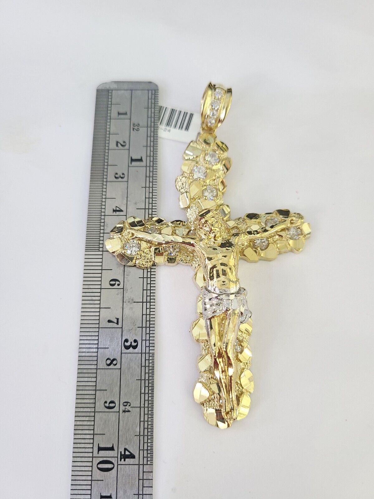 Side angle view of 10K yellow gold Jesus crucifix pendant on Franco chain