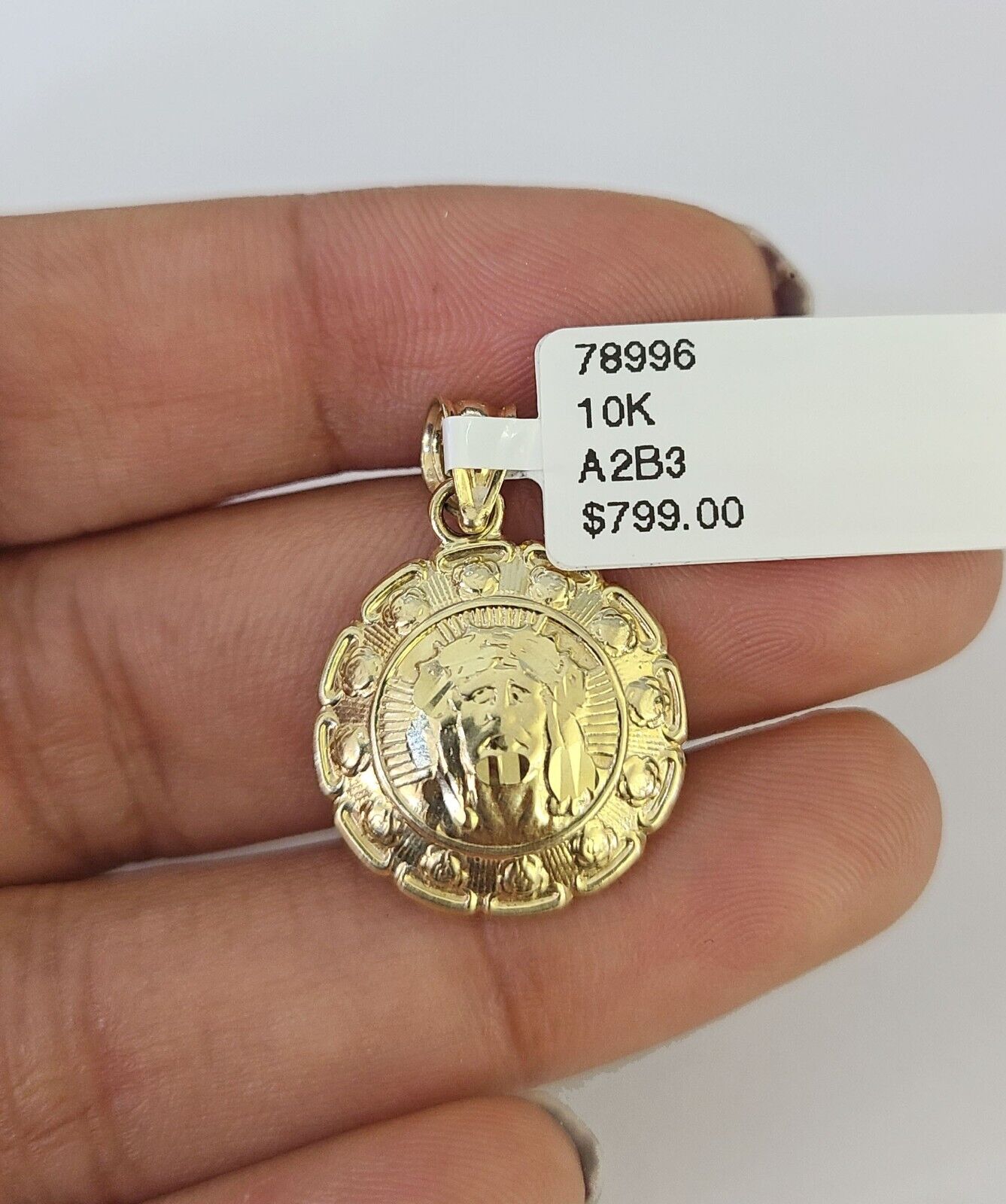 Lifestyle or alternate angle view of 10K gold Jesus and Mary necklace by Reva Jeweler