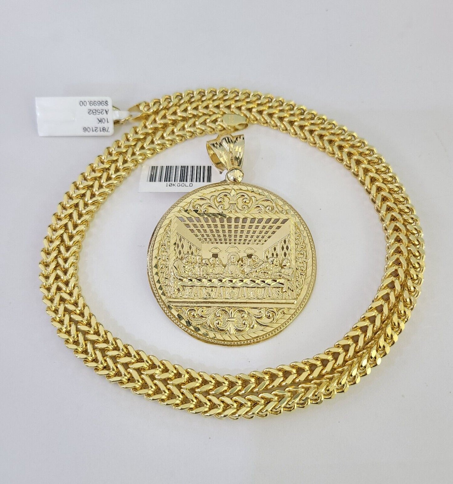 Flat lay display of Reva Jeweler 10K yellow gold Last Supper necklace set
