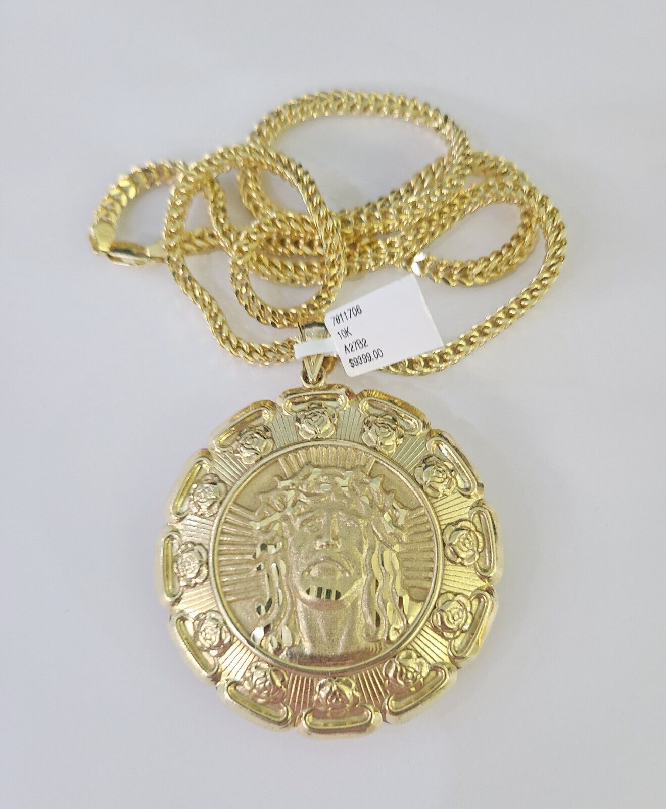 Flat lay display of Reva Jeweler 10K yellow gold Jesus and Virgin Mary necklace set