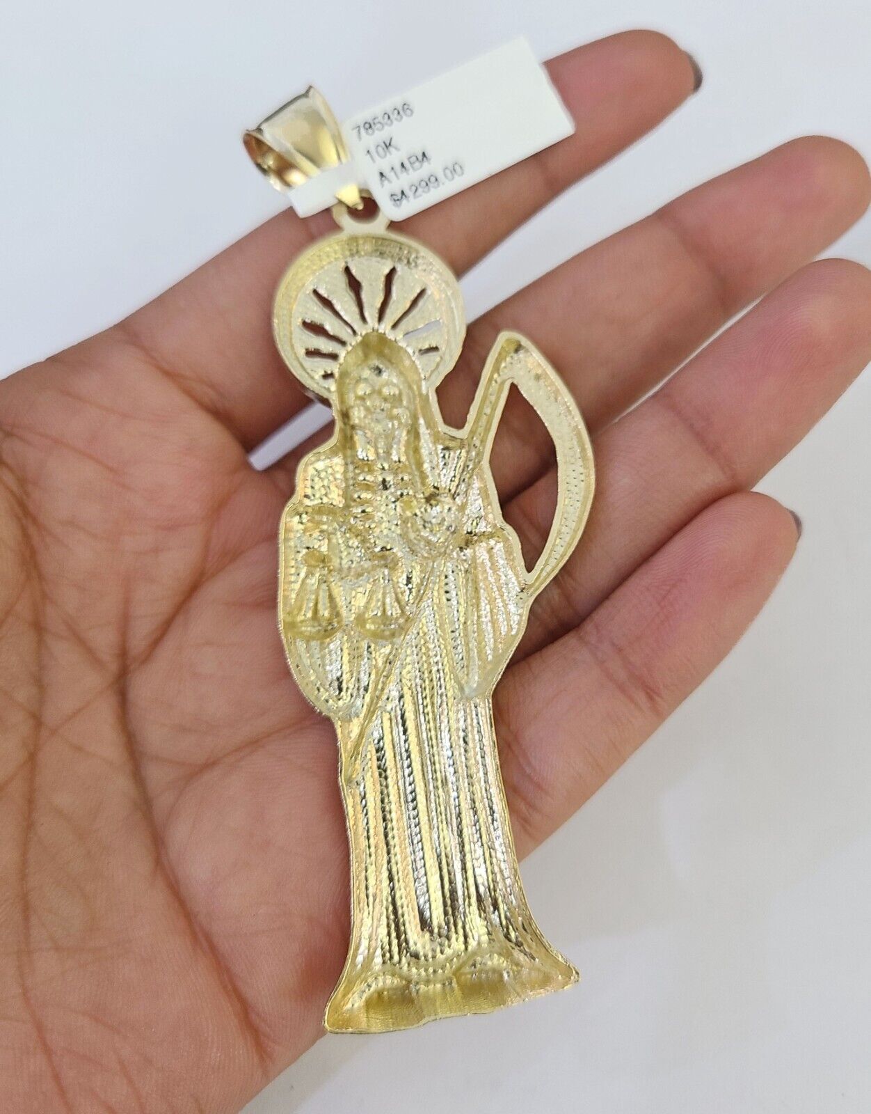 Close-up detailed view of 10K yellow gold Saint Reaper pendant charm