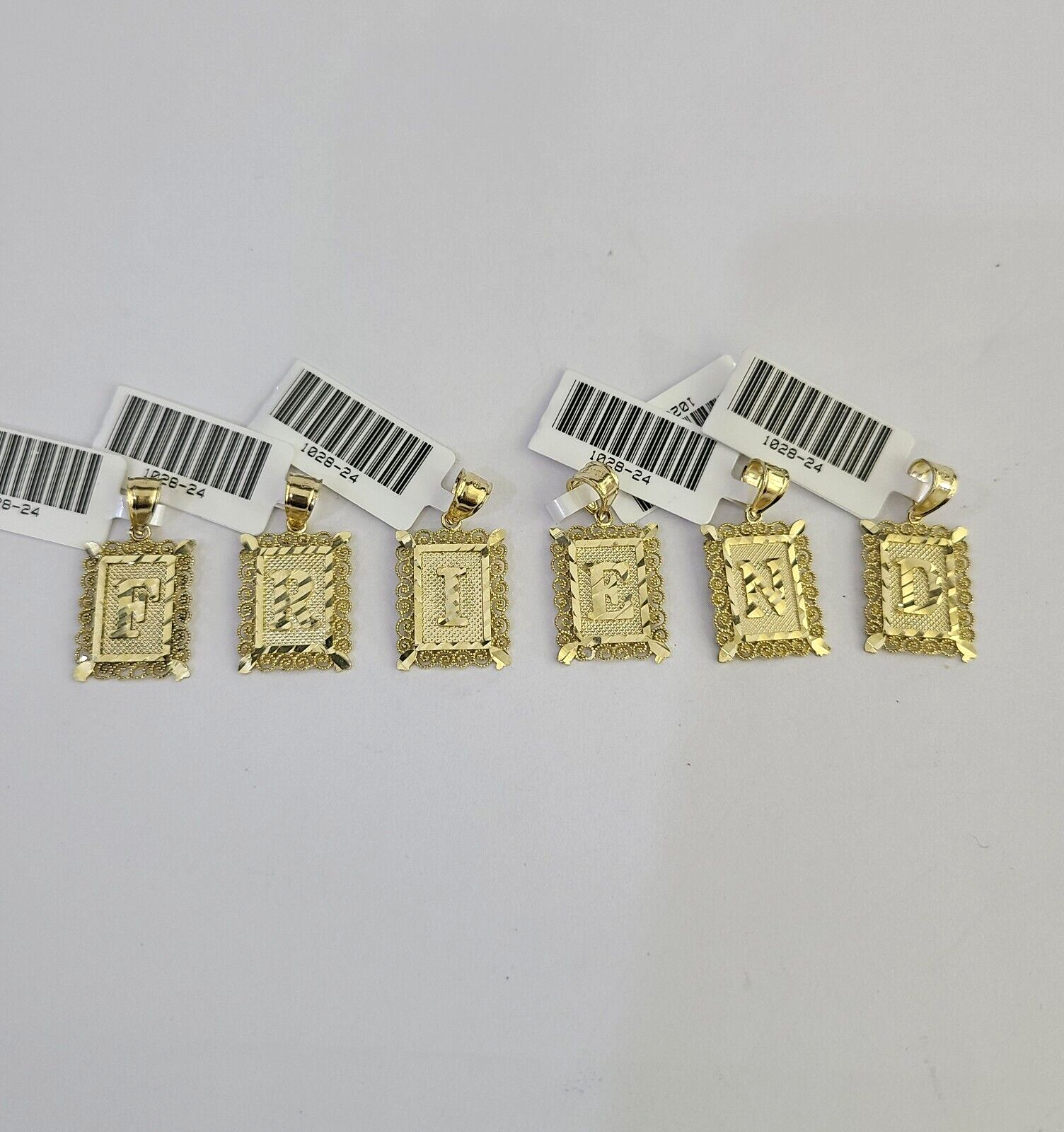 Front view of gold letter charm