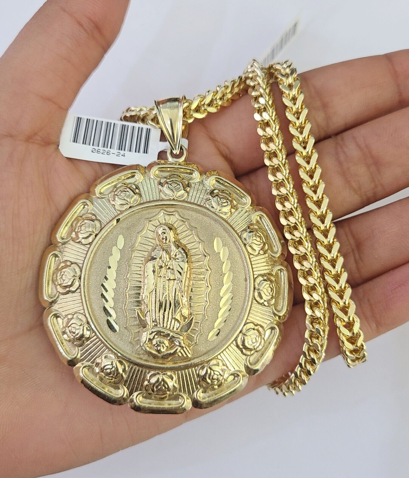 Front-facing view of Reva Jeweler 10K gold Jesus and Mary pendant and chain