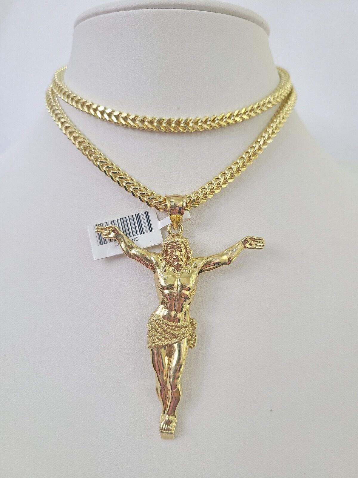 Front-facing view of Reva Jeweler 10K gold Jesus pendant and chain