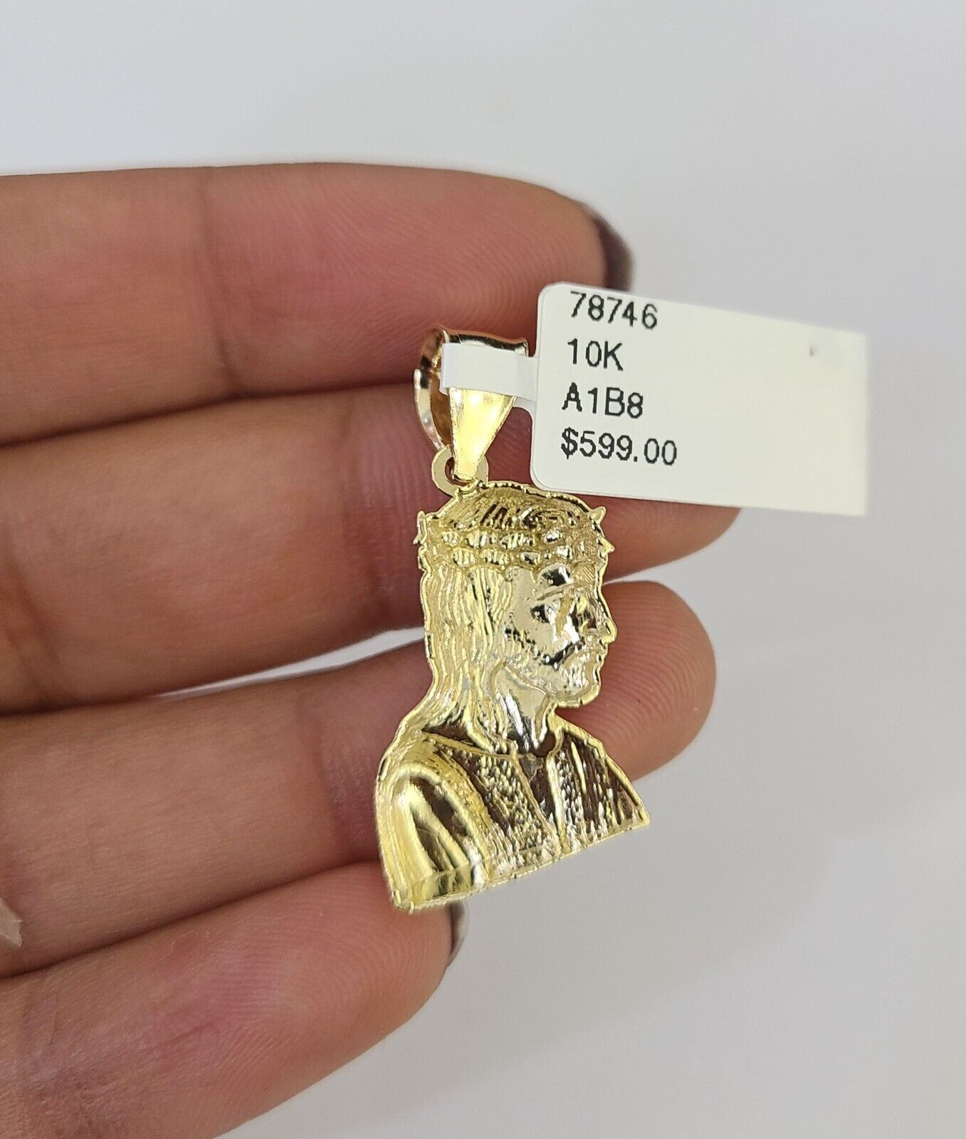 Side angle view of 10K yellow gold Jesus head pendant on Franco chain