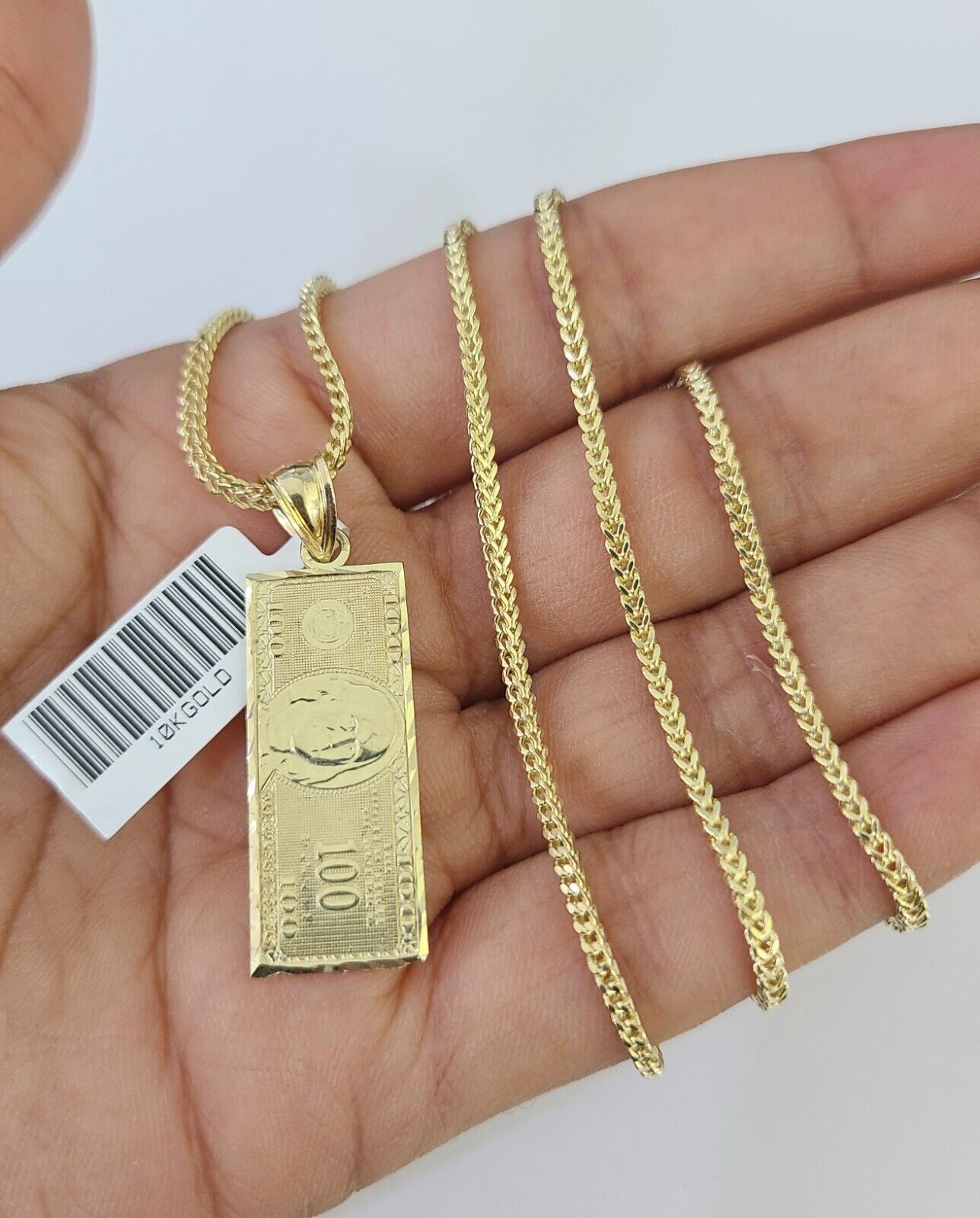 Front view of 10K gold 100 dollar pendant necklace set on Franco chain