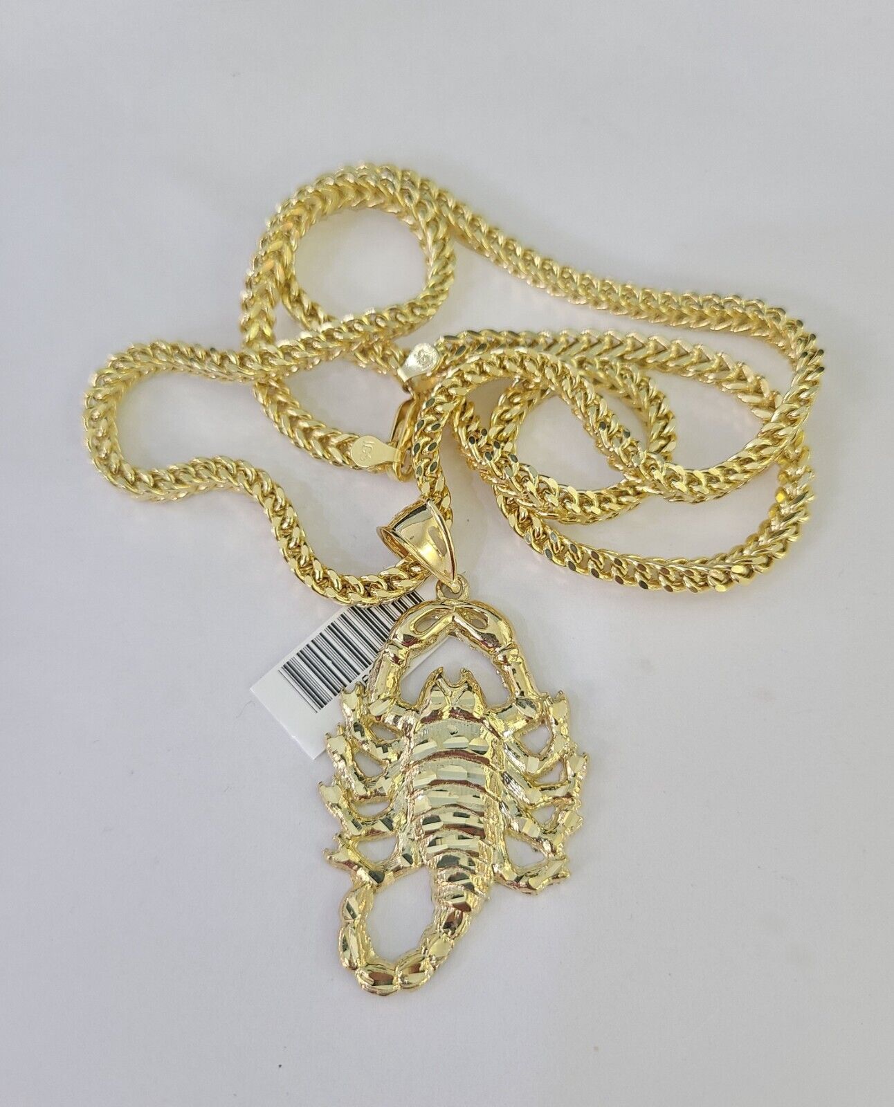 Front-facing view of Reva Jeweler 10K gold Scorpio pendant and chain