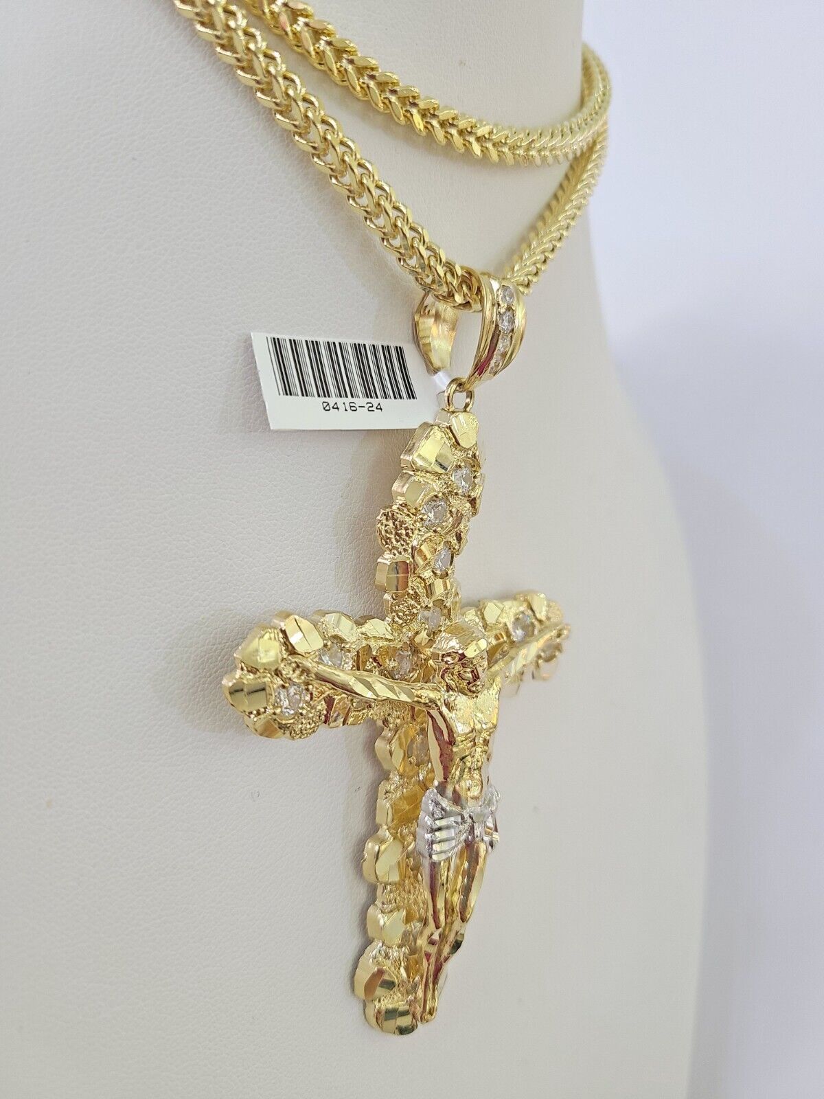 Full display of 10K yellow gold Franco chain with Jesus crucifix pendant