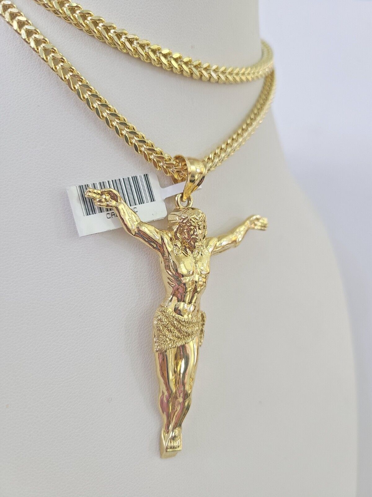 Full display of 10K yellow gold Franco chain with Jesus pendant