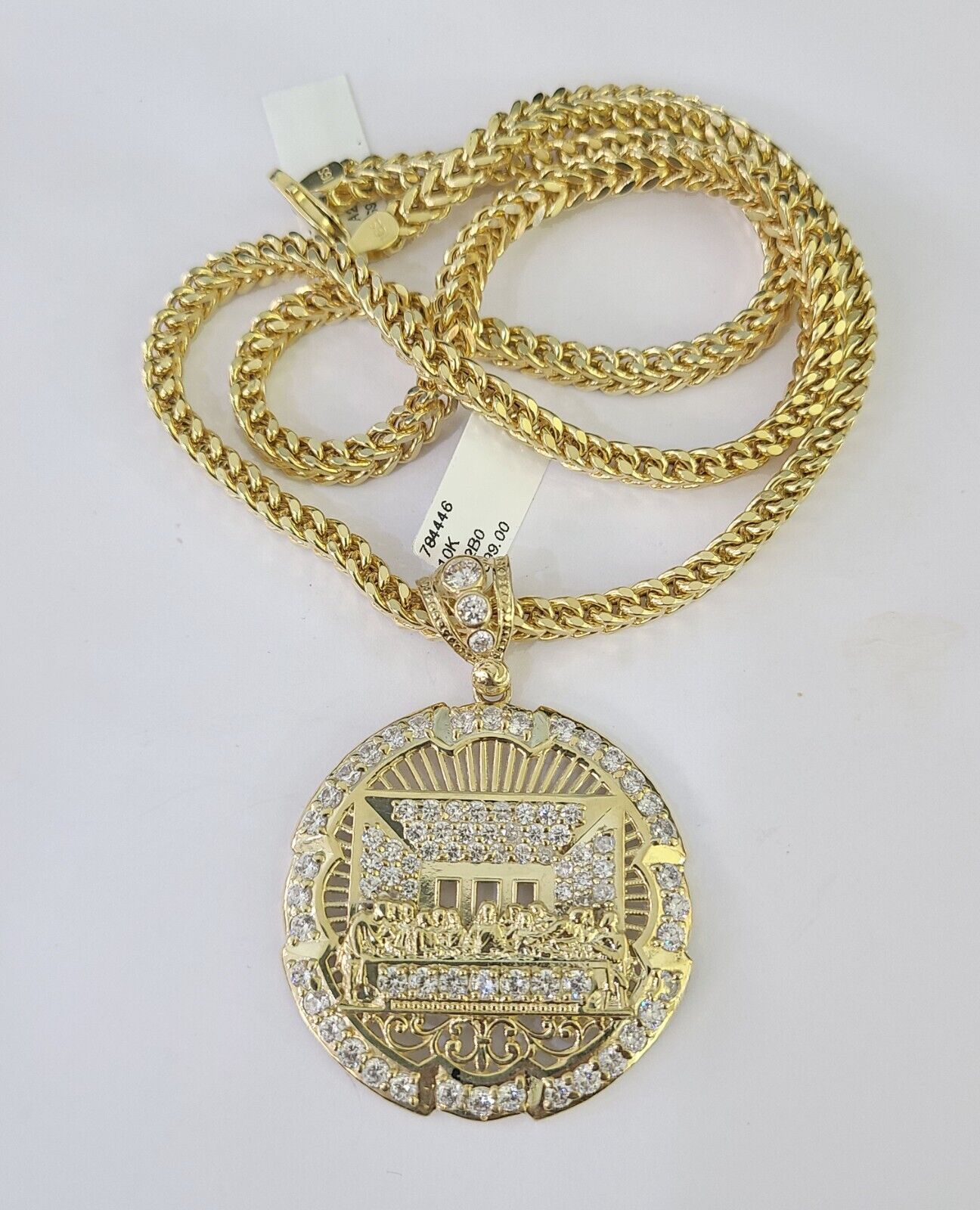 Side angle view of 10K yellow gold Last Supper pendant on Franco chain