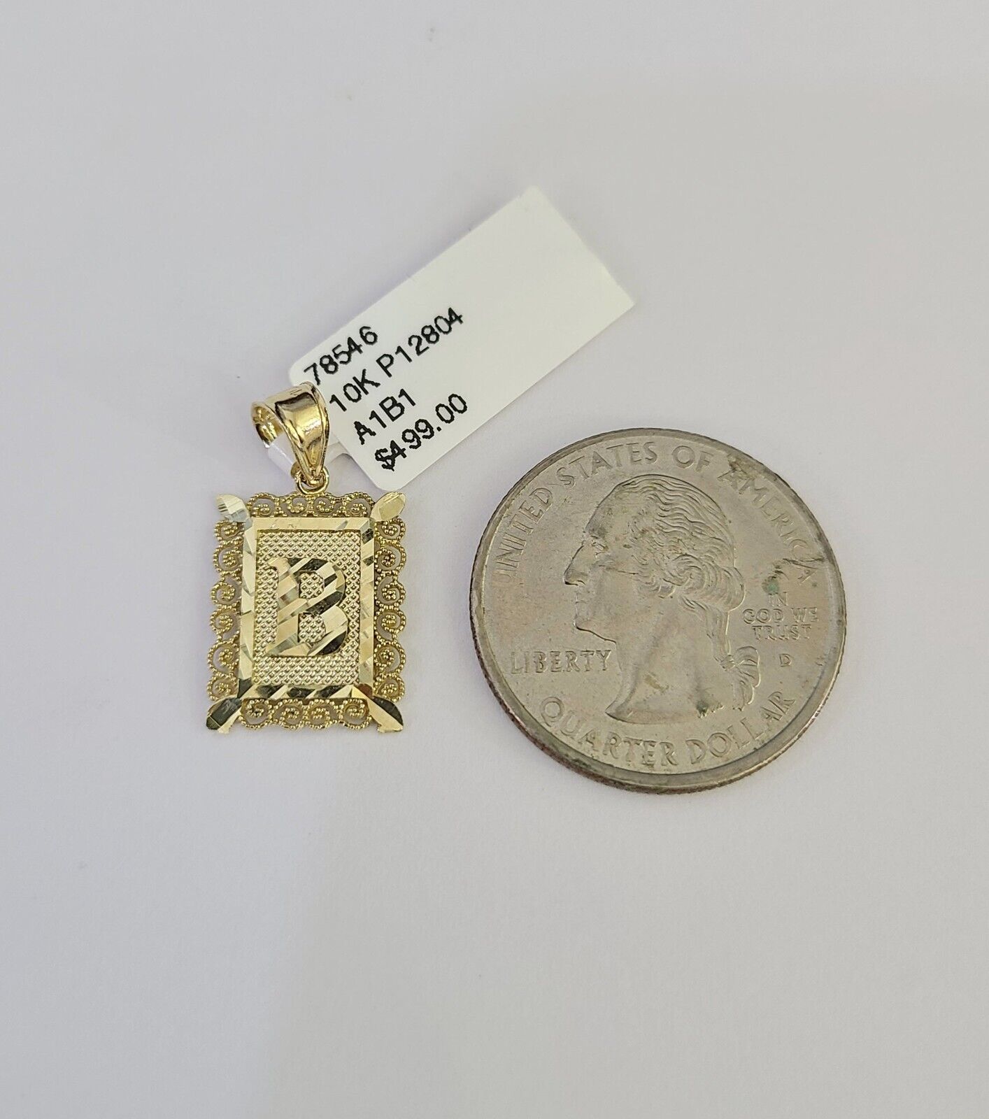 Gold initial pendant studio view