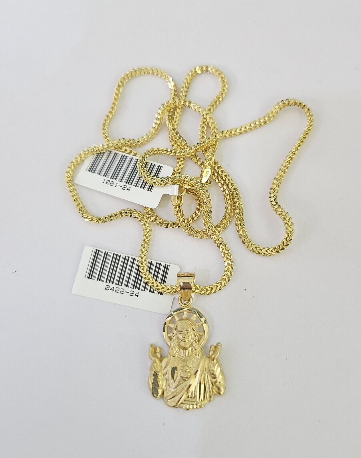 Full display of 10K yellow gold Franco chain with Jesus pendant