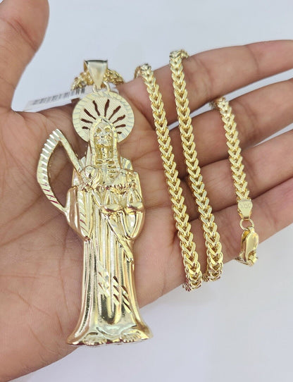 Side angle view of 10K yellow gold Saint Reaper pendant on Franco chain
