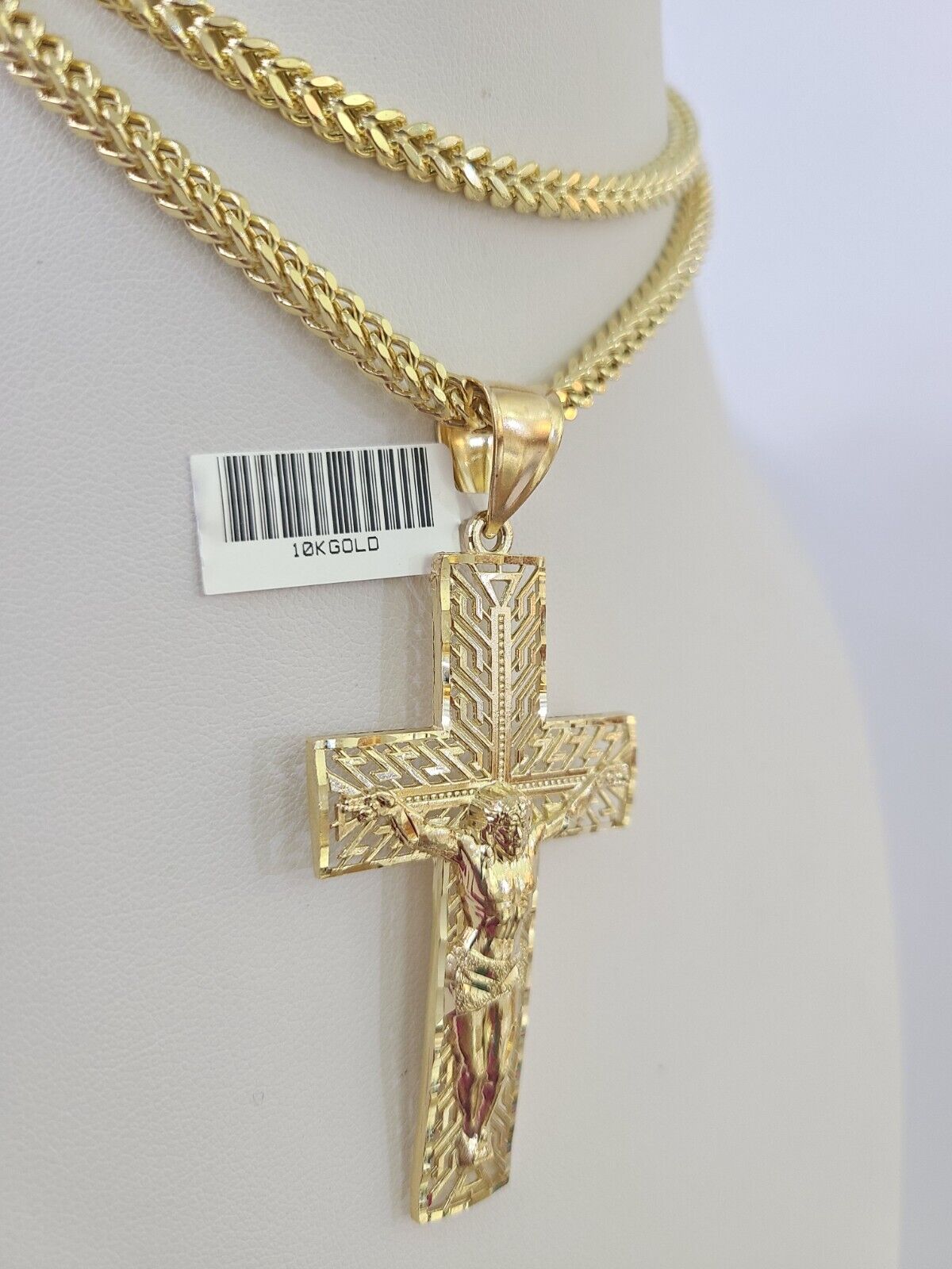 Close-up detailed view of 10K yellow gold Jesus crucifix pendant charm