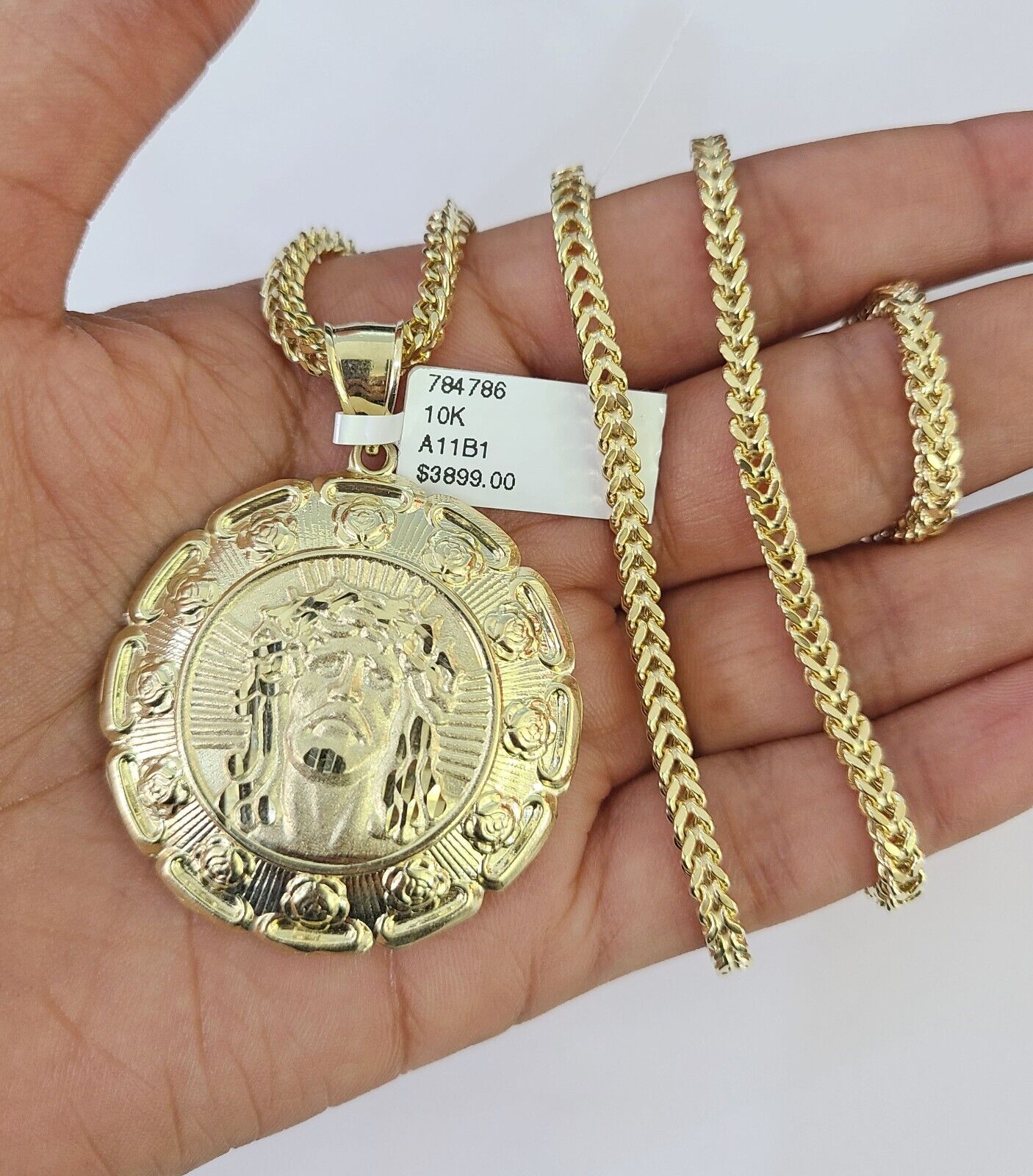 Front-facing view of Reva Jeweler 10K gold Jesus and Mary pendant and chain