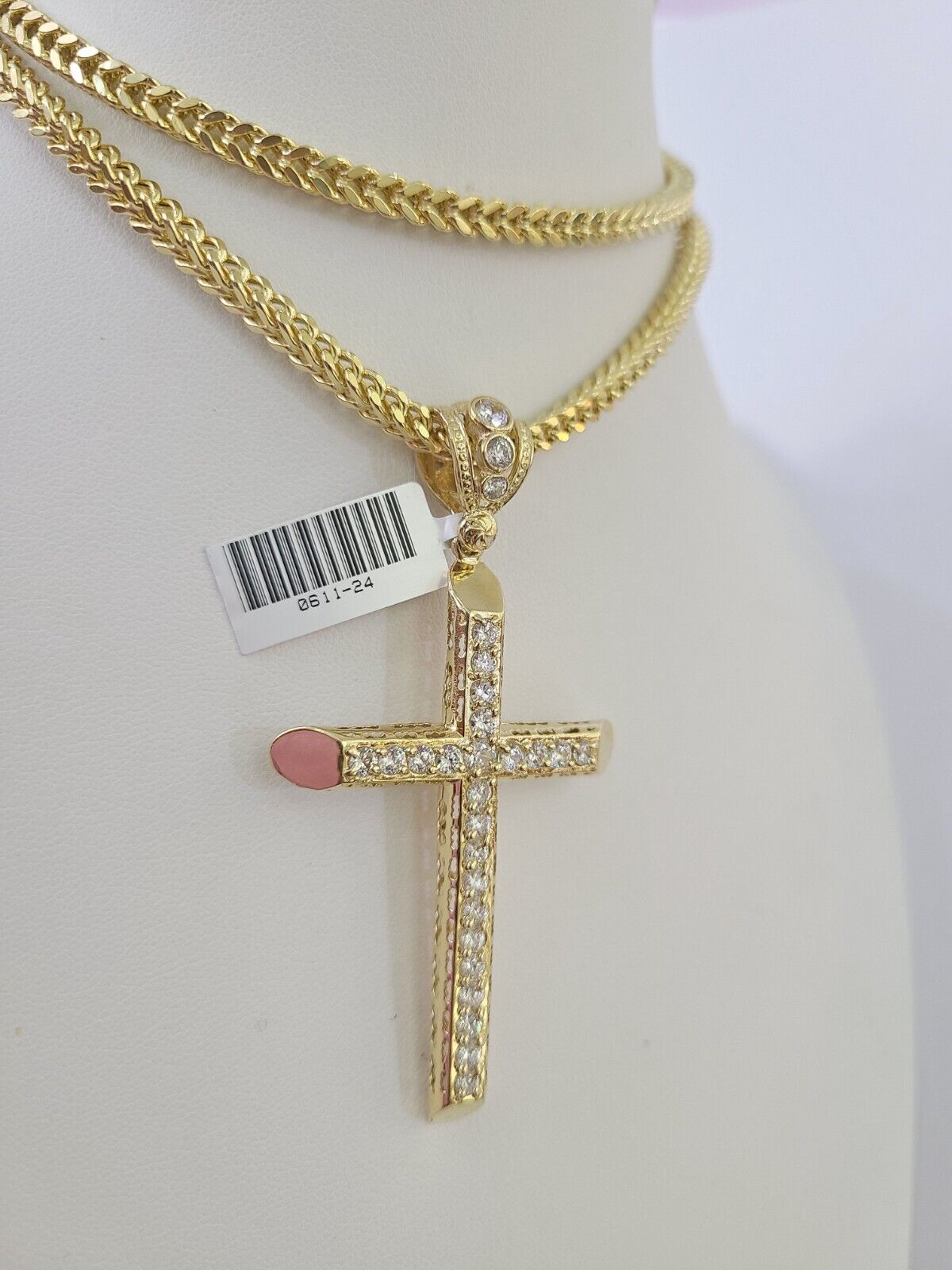 Front-facing view of Reva Jeweler 10K gold cross pendant and chain