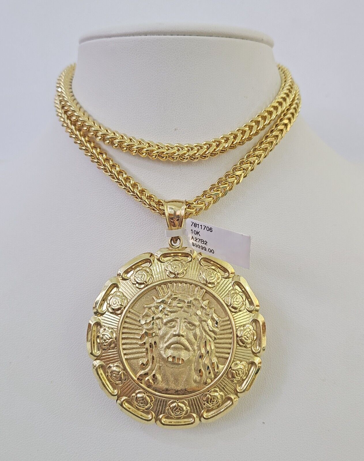 Side angle view of 10K yellow gold Jesus and Mary pendant on Franco chain