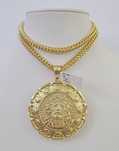 Side angle view of 10K yellow gold Jesus and Mary pendant on Franco chain