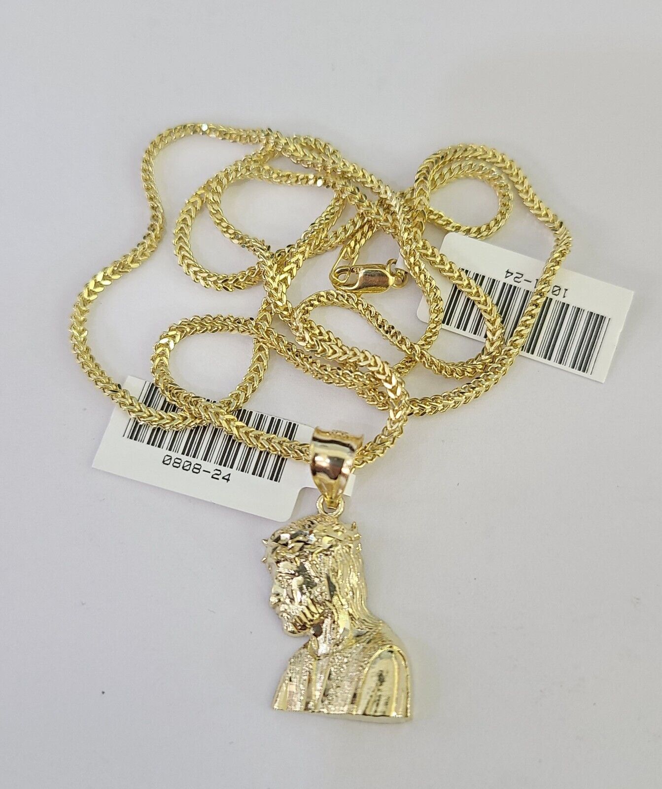Close-up detailed view of 10K yellow gold Jesus head pendant charm