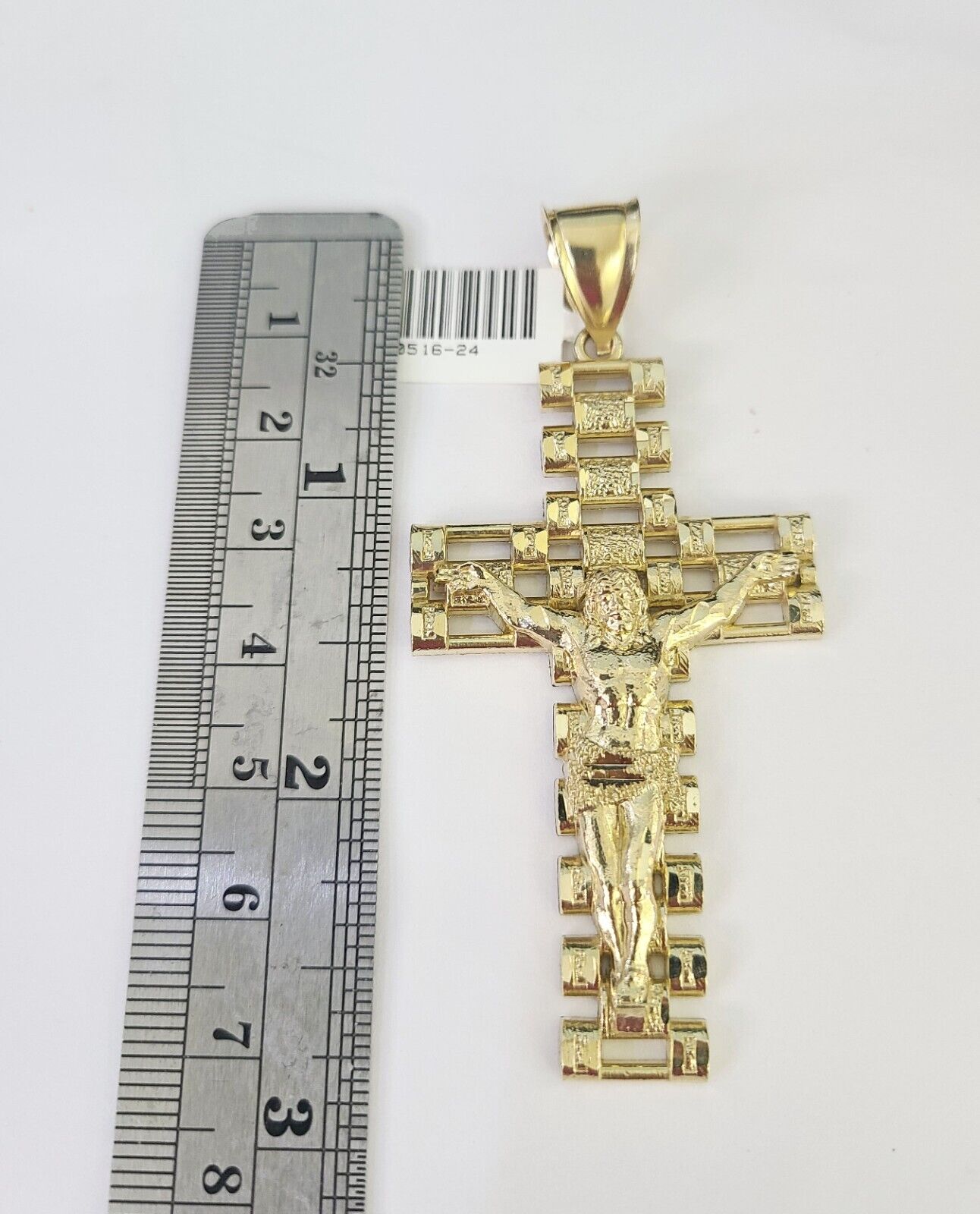 Close-up detailed view of 10K yellow gold Jesus crucifix pendant charm