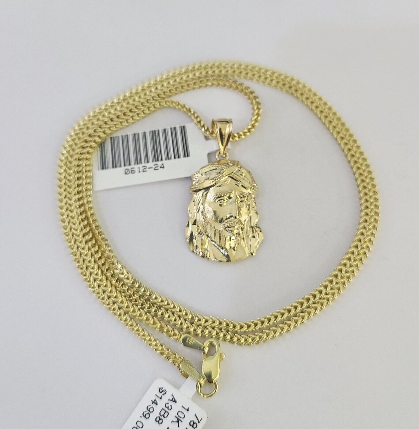 Lifestyle or alternate angle view of 10K gold Jesus head necklace by Reva Jeweler
