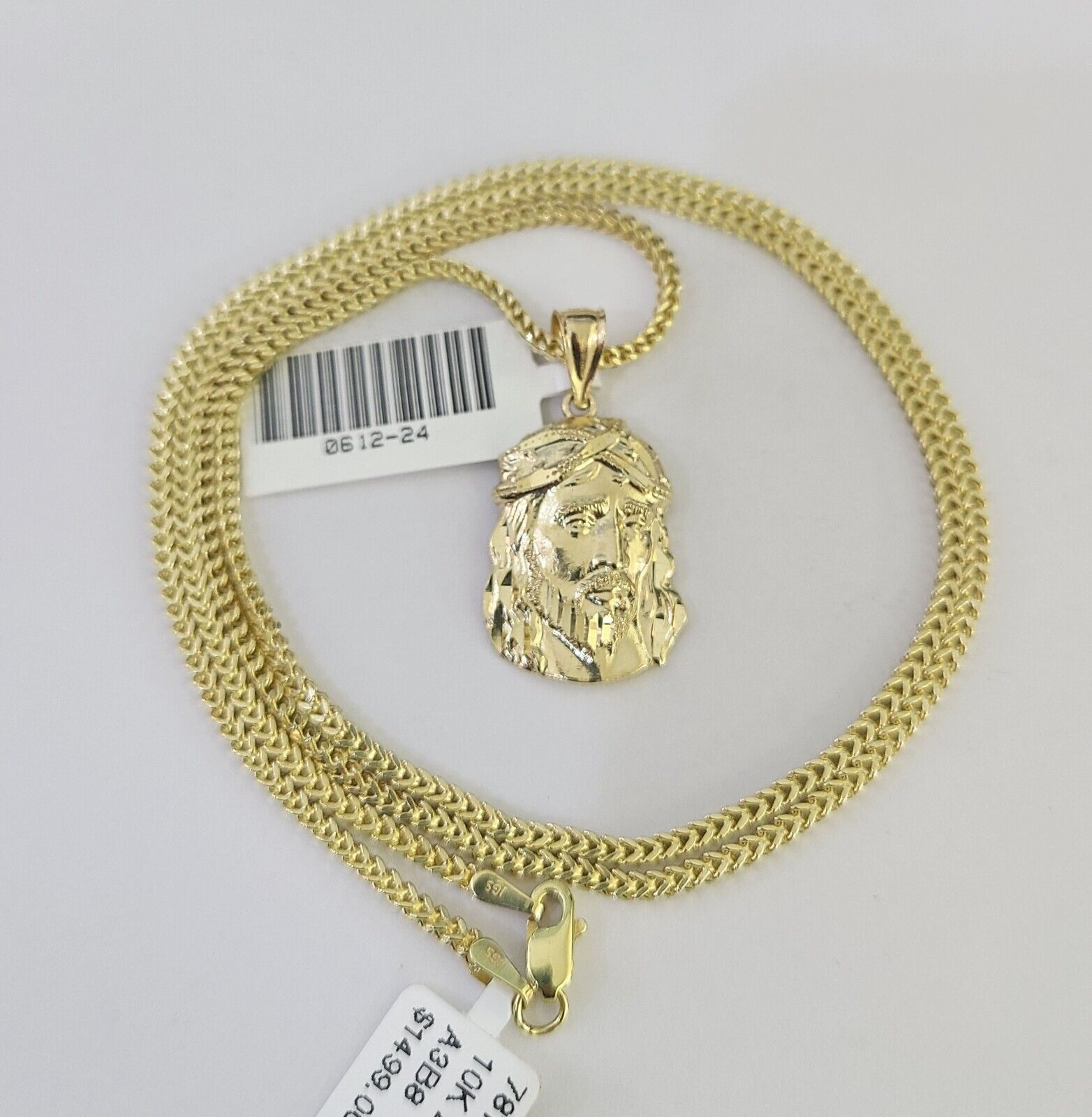 Lifestyle or alternate angle view of 10K gold Jesus head necklace by Reva Jeweler
