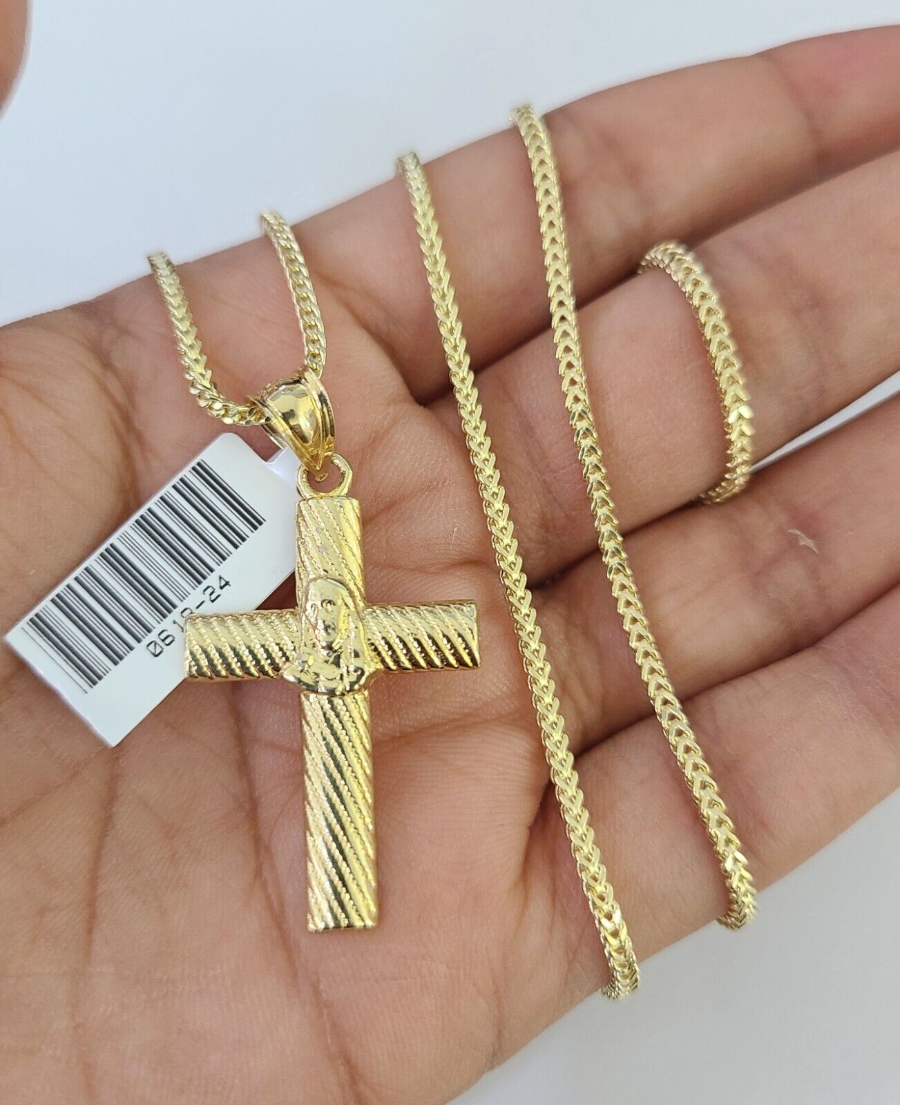 Side angle view of Franco chain necklace featuring Jesus cross pendant charm
