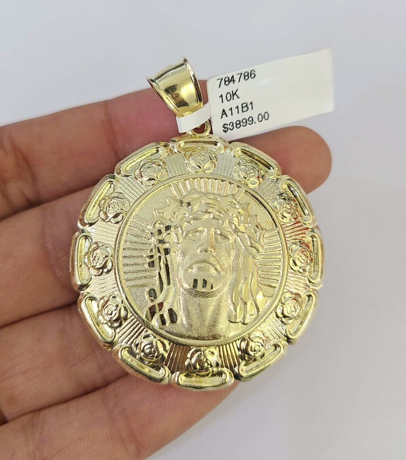 Full display of 10K yellow gold Franco chain with Jesus and Mary pendant