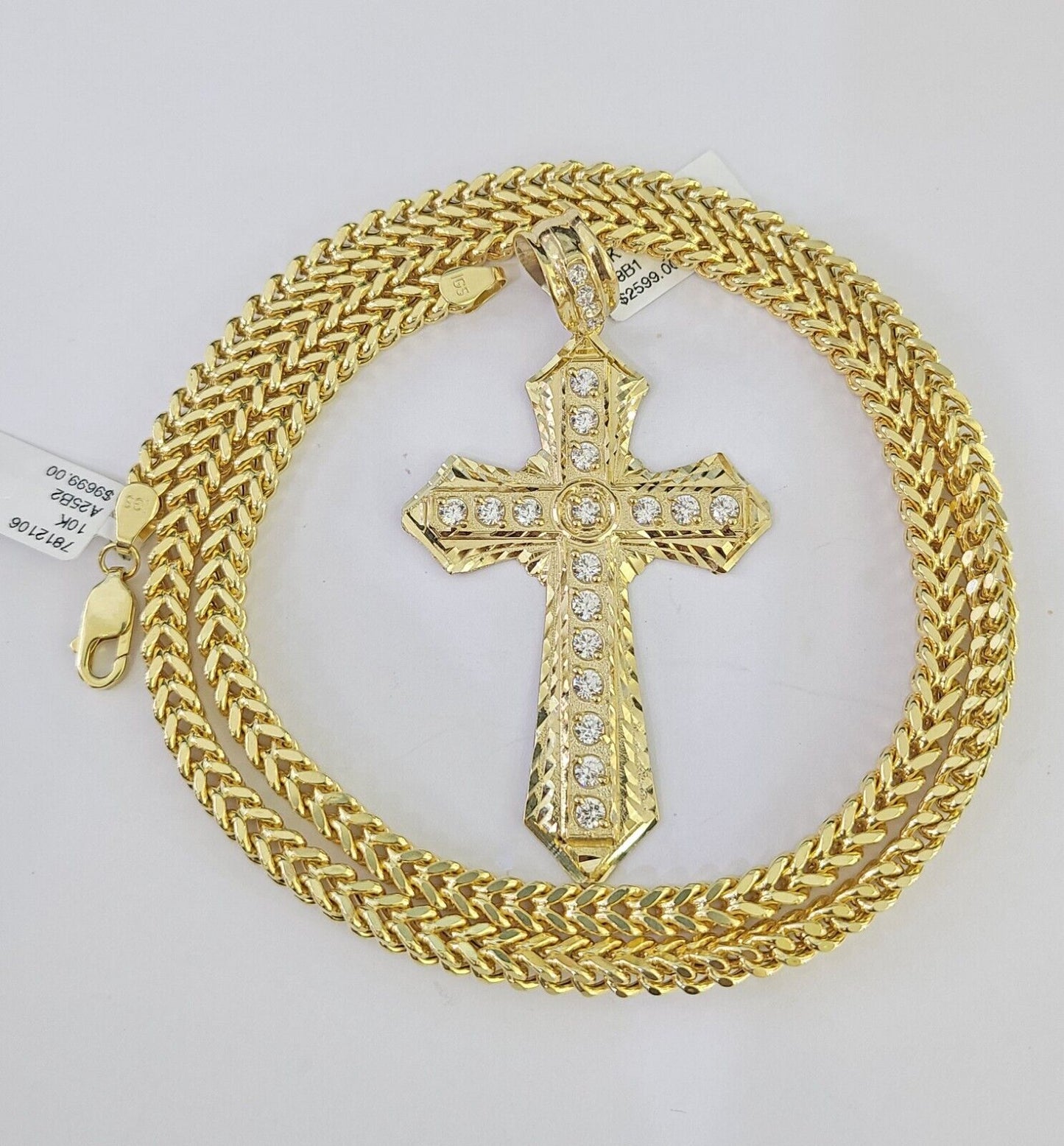 Close-up of 10K yellow gold Jesus cross pendant on Franco chain necklace