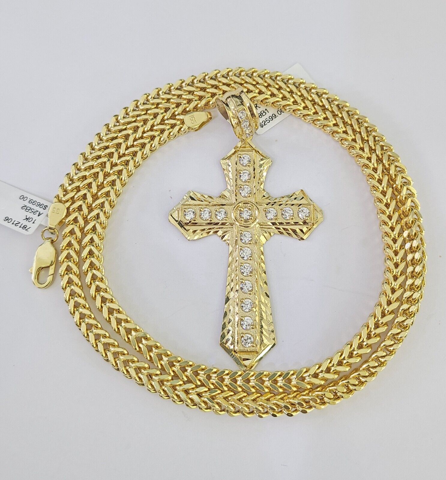 Close-up of 10K yellow gold Jesus cross pendant on Franco chain necklace